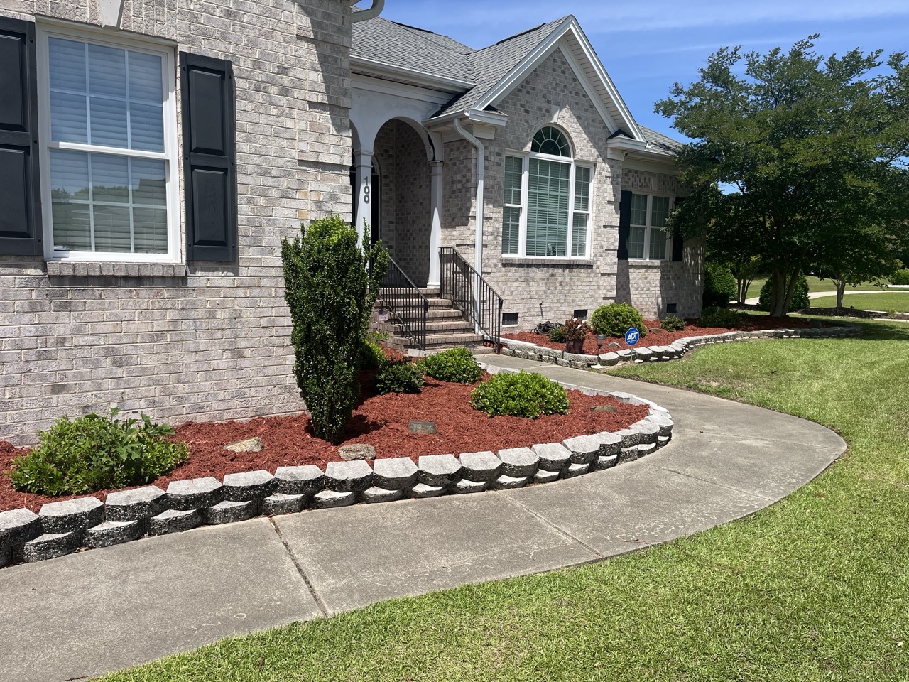 the exterior of a home beautifully landscaped by Walston Evans
