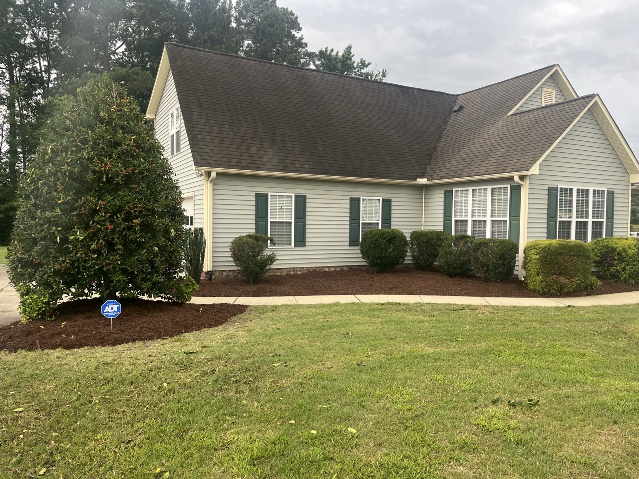 a beautiful exterior of a home that has been landscaped by Walston Evans