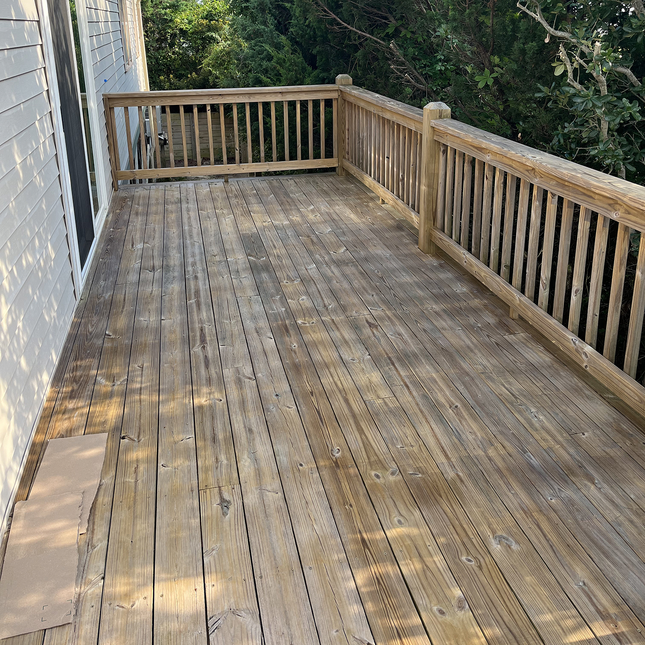 a wooden deck being stained by Walston Evans