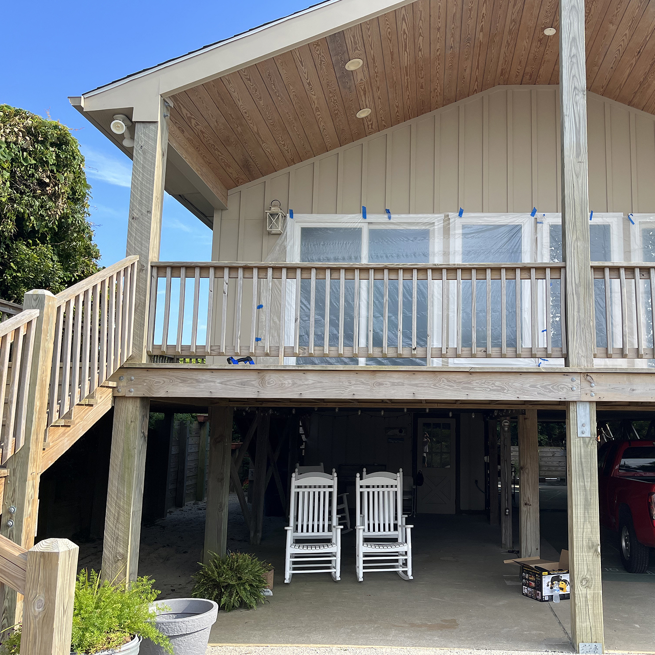 a deck of a home being stained by Walston Evans