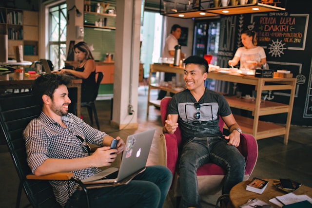Two men sitting together, laughing