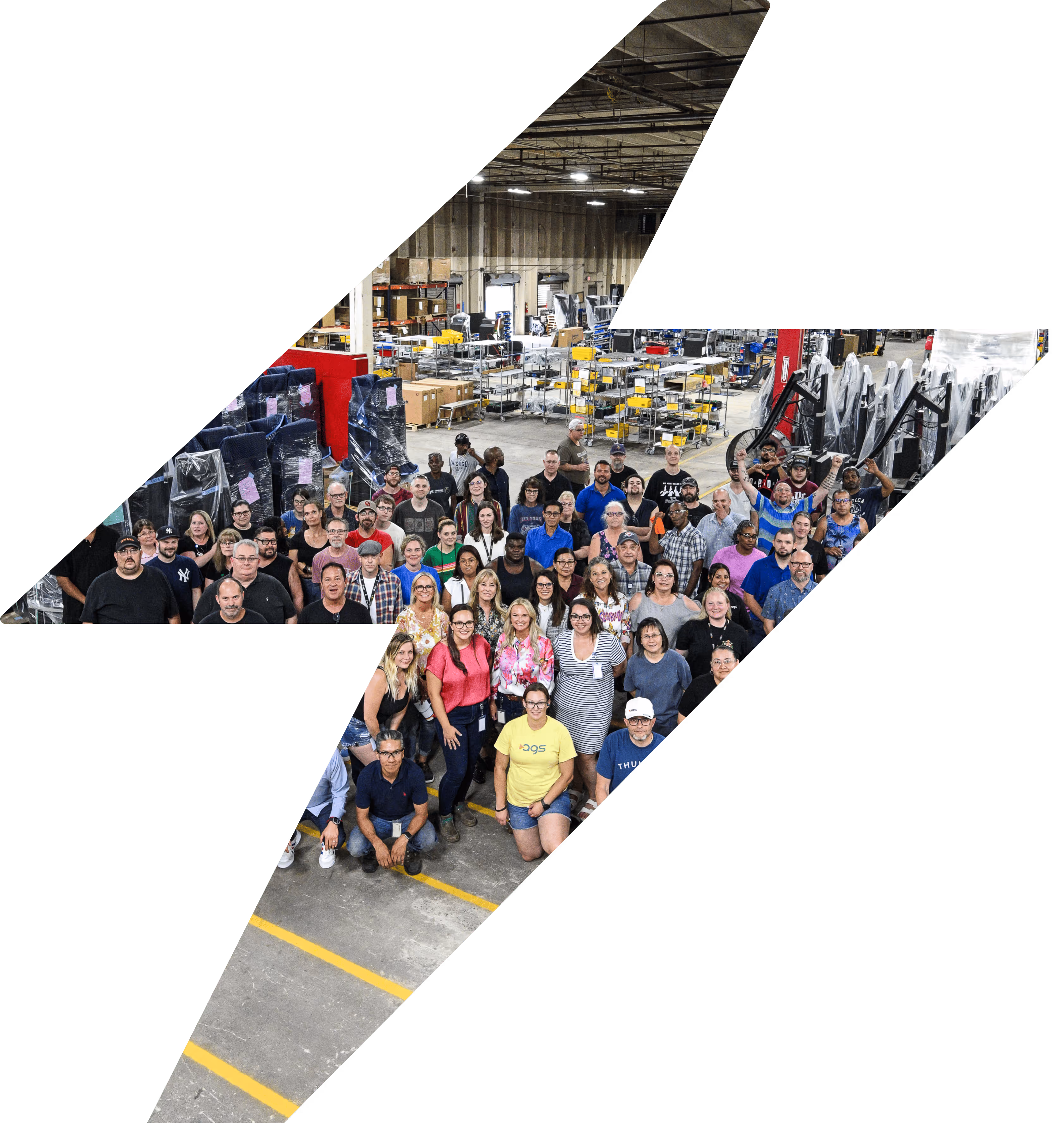 AGS team photo in manufacturing facility with diverse workforce