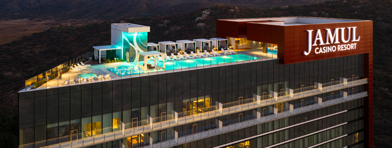 Slot machine screen featuring a muscular werewolf holding gold coins and a potion bottle, with colorful game symbols below and other slot machines in the background.
