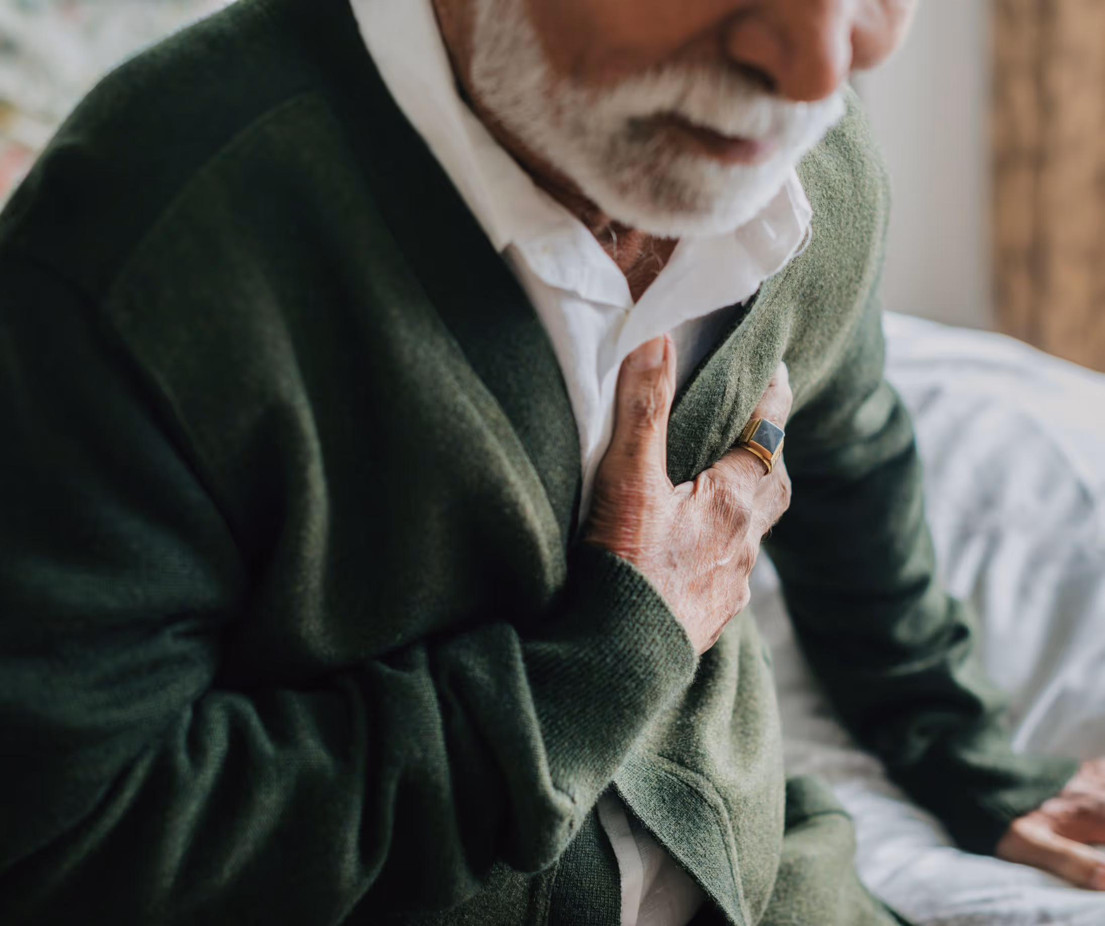 Older man in Los Angeles with acid reflux, exploring cause and treatment options for heartburn