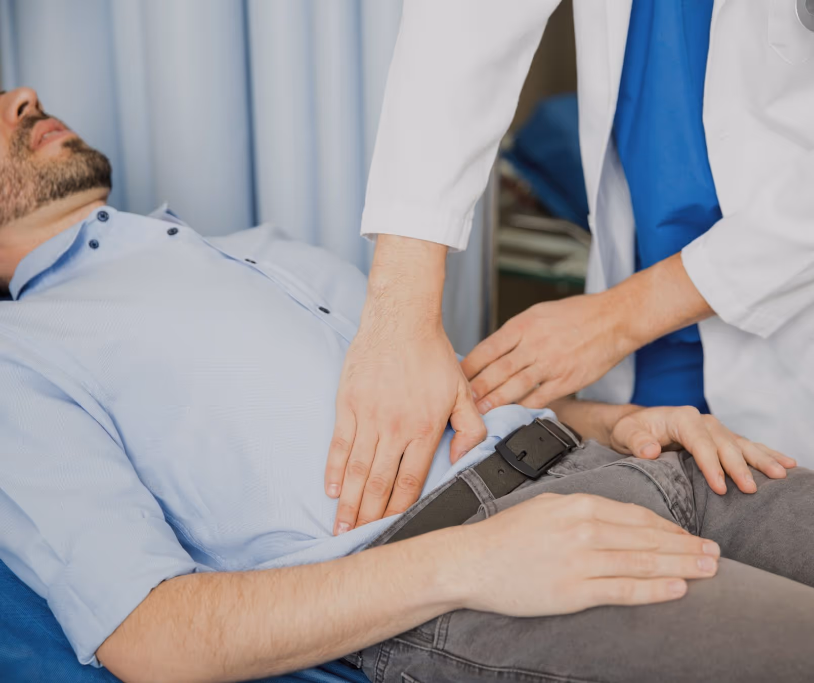 Man in Beverly Hills with recurring stomach pain getting a detailed evaluation for treatment options.