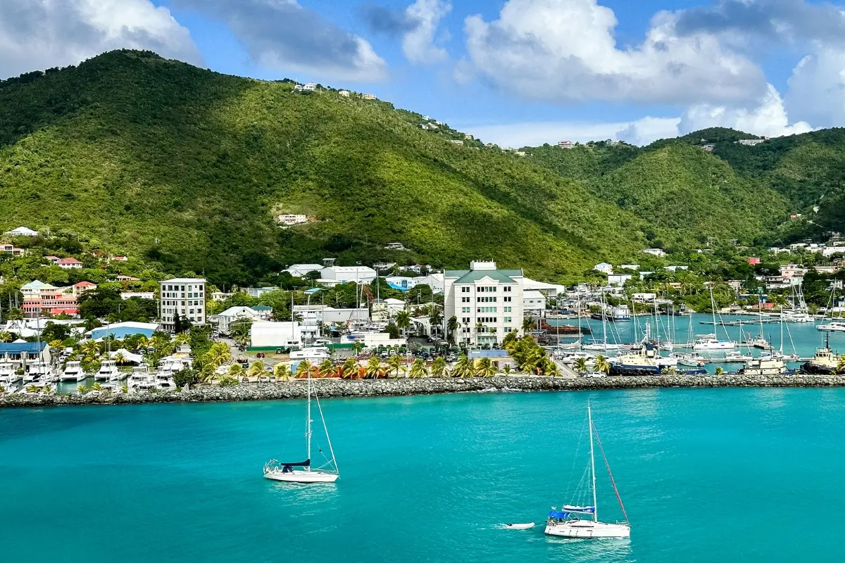 Sailboats anchored in the turquoise harbor of Road Town, Tortola in the British Virgin Islands, a common starting and ending point for yacht charters.