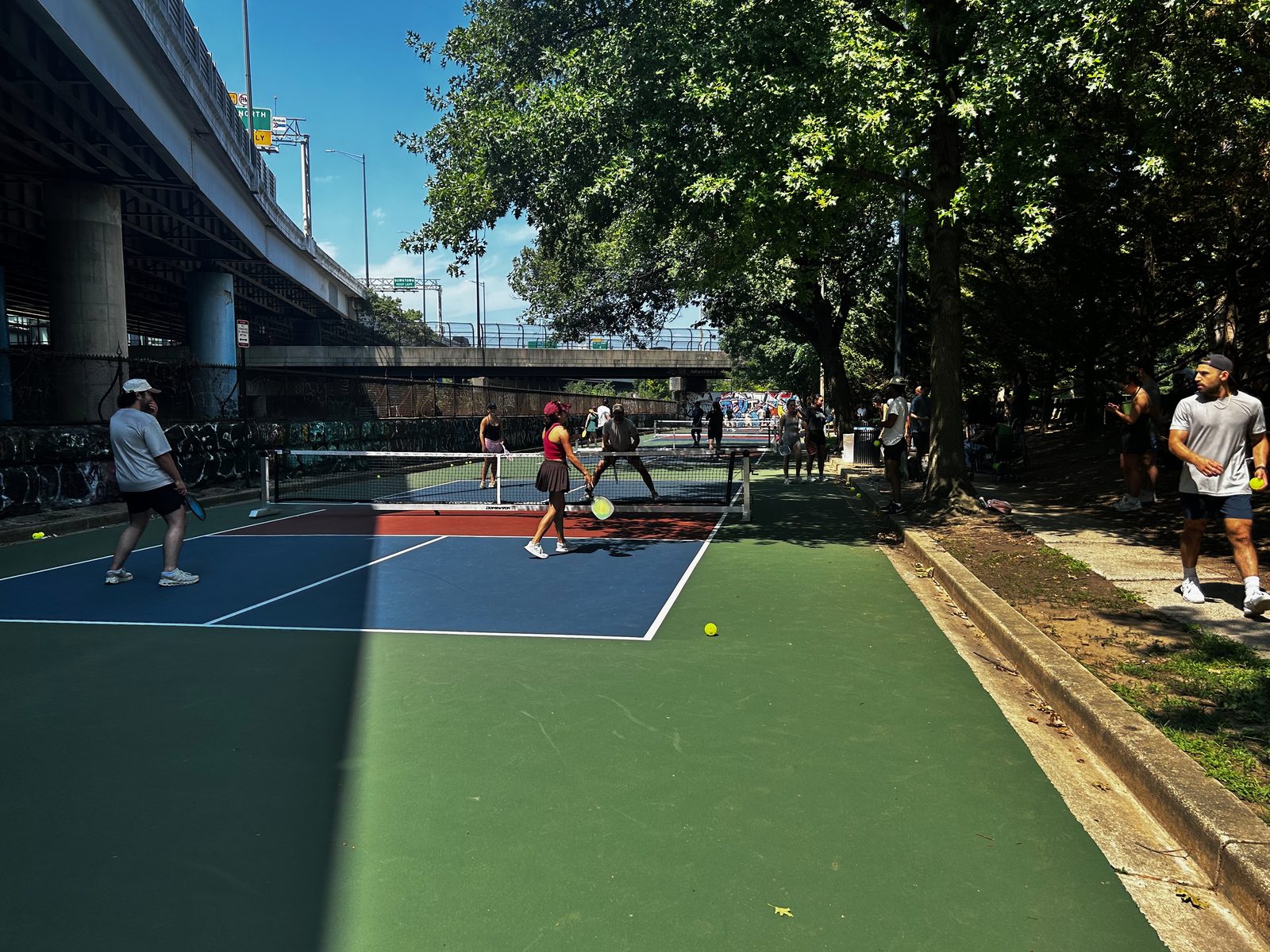 Players and spectators at the finished Krughoff Pickleball Center courts on a summer day