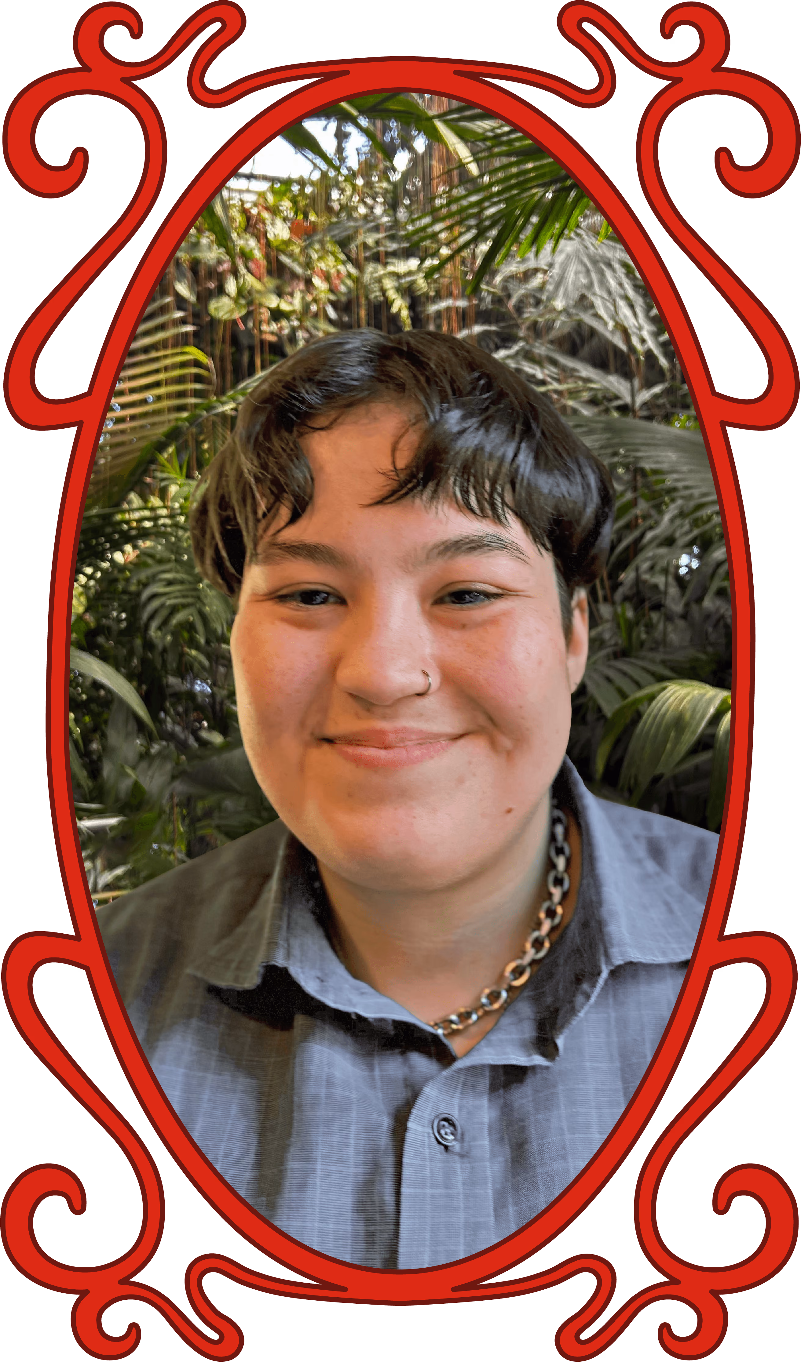 Portrait of a smiling person with short dark hair, a nose ring, and a chain necklace, wearing a gray shirt, against a background of lush green plants, framed by an ornate red oval border.