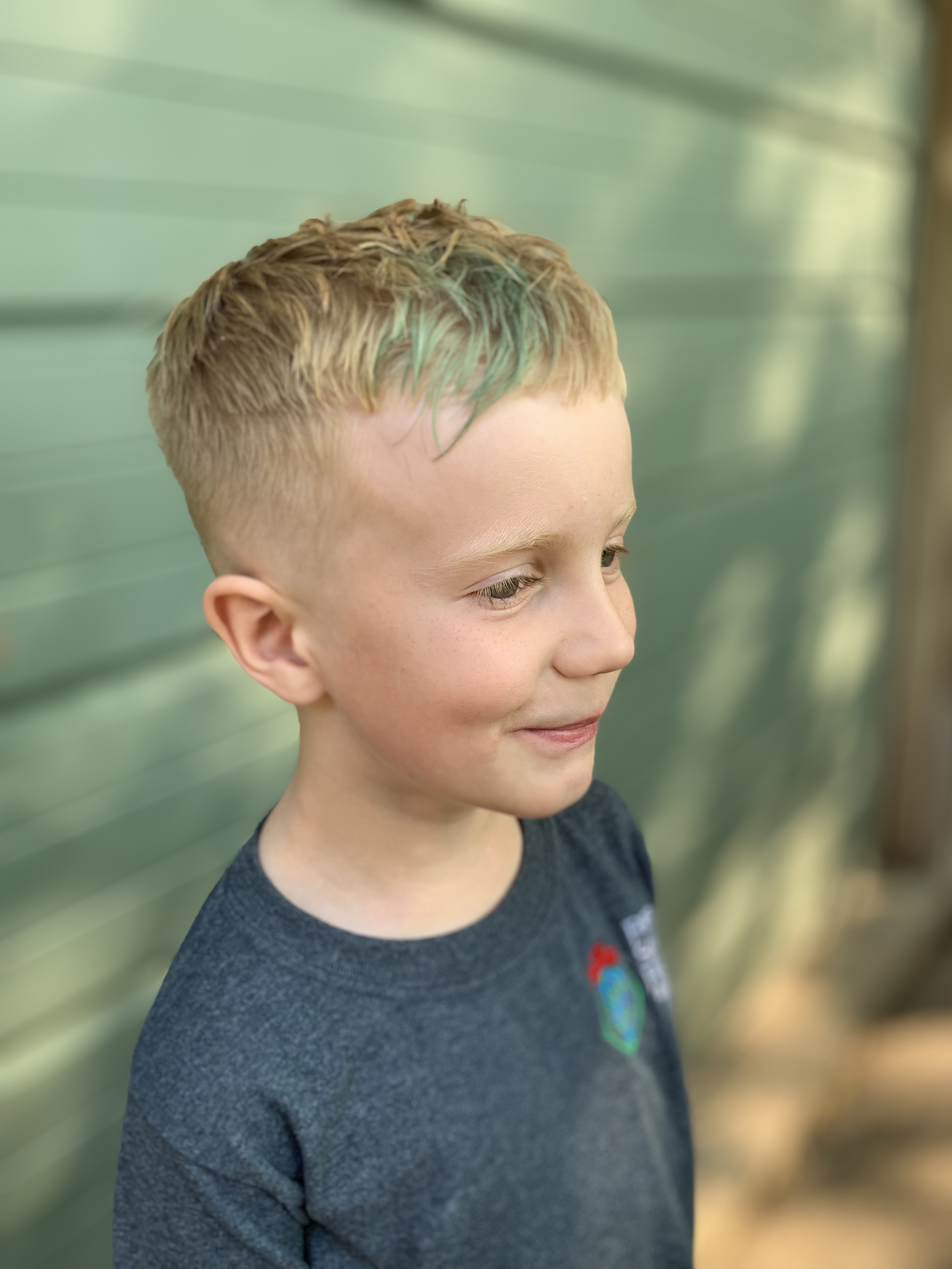 Male child with blond hair and a low fade 