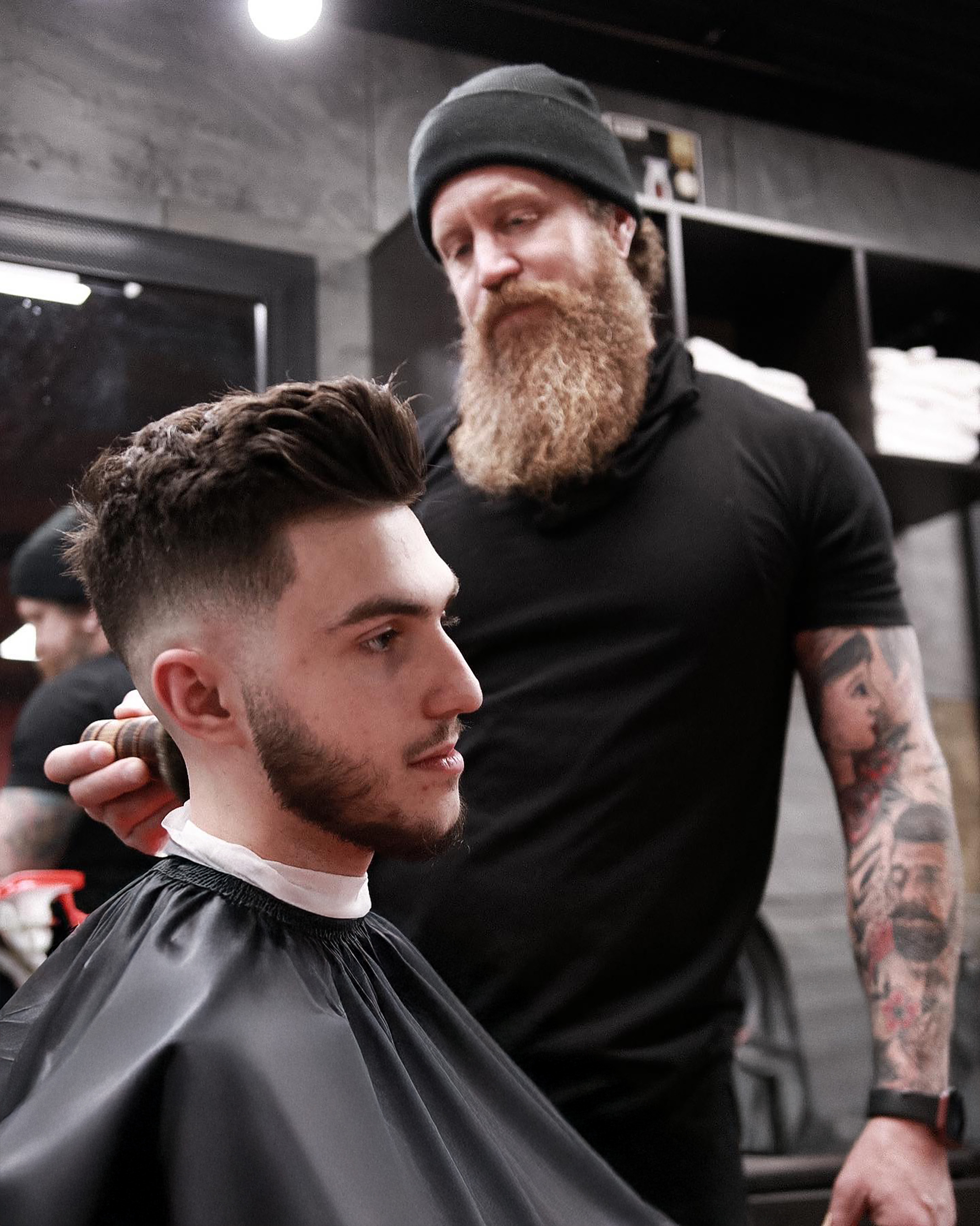 Joel, the barber finishing a mens cut