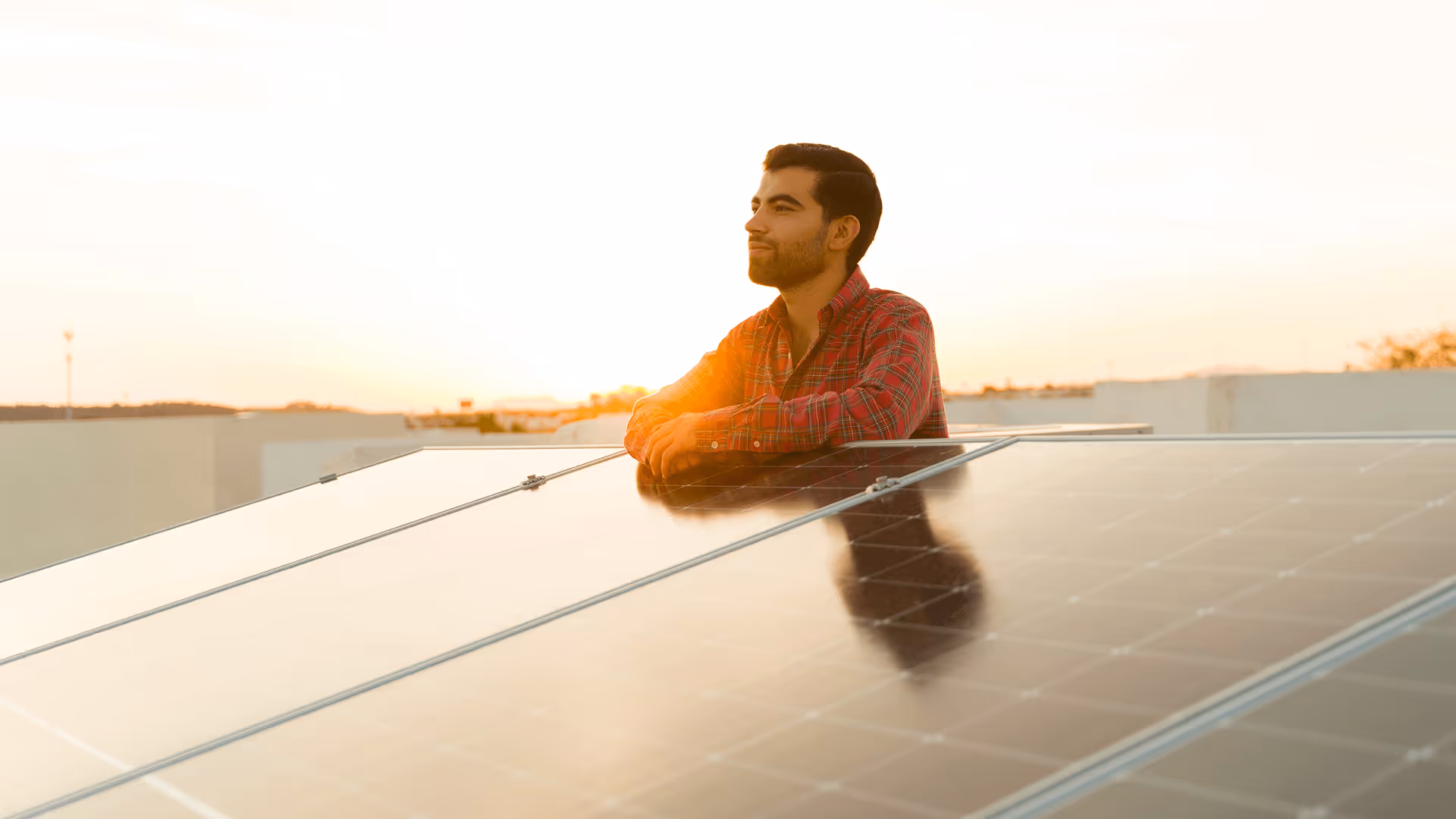 Solar mounting systems South Africa – installer inspecting panels at sunset, reflecting commitment to reliability.