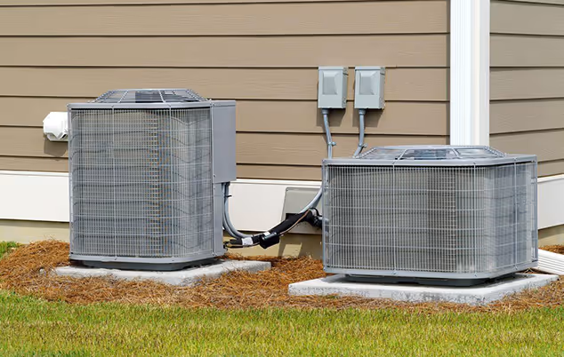 Air conditioning technician repairing a unit in a Miami home, tools and equipment visible in a bright indoor setting.