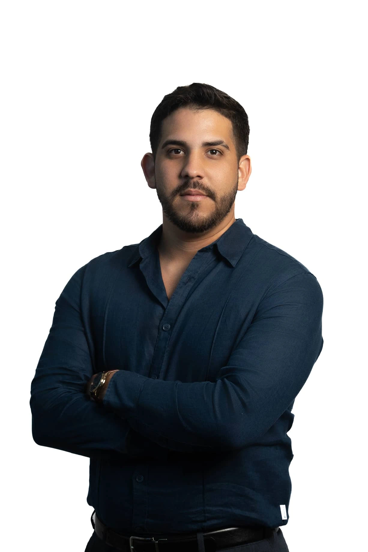a man with his arms crossed posing for a picture
