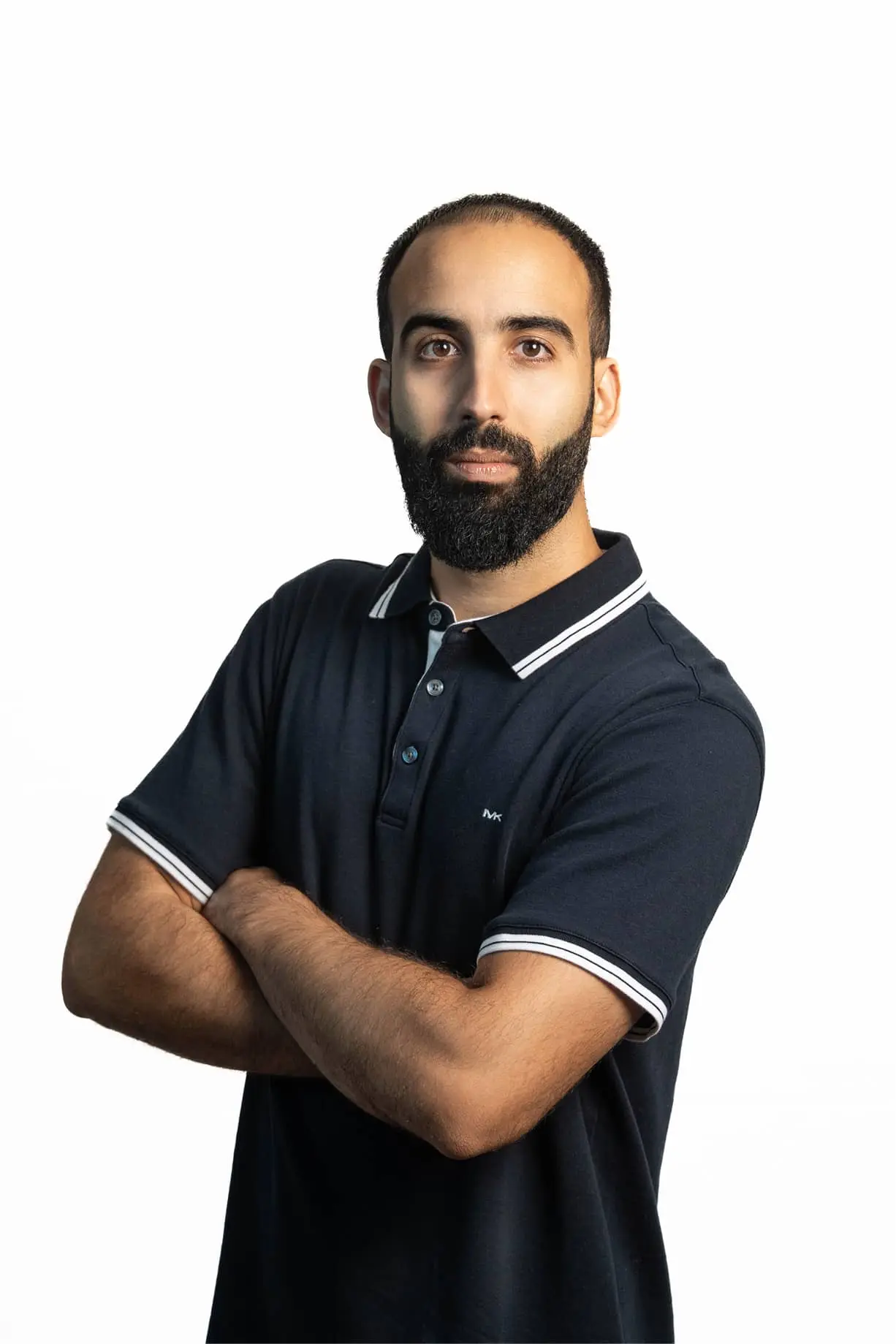 a man with a beard wearing a polo shirt