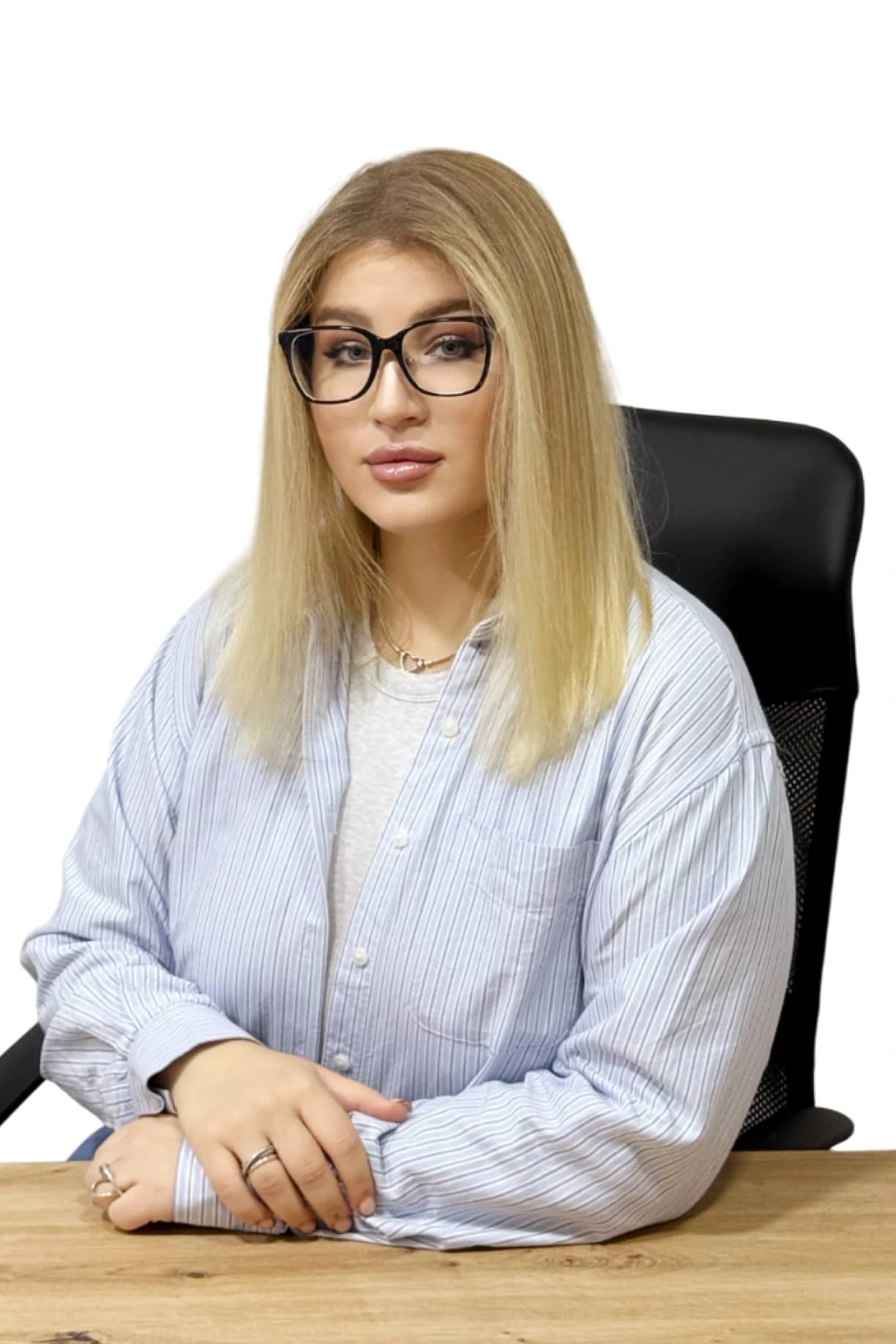 a woman with glasses sitting at a desk