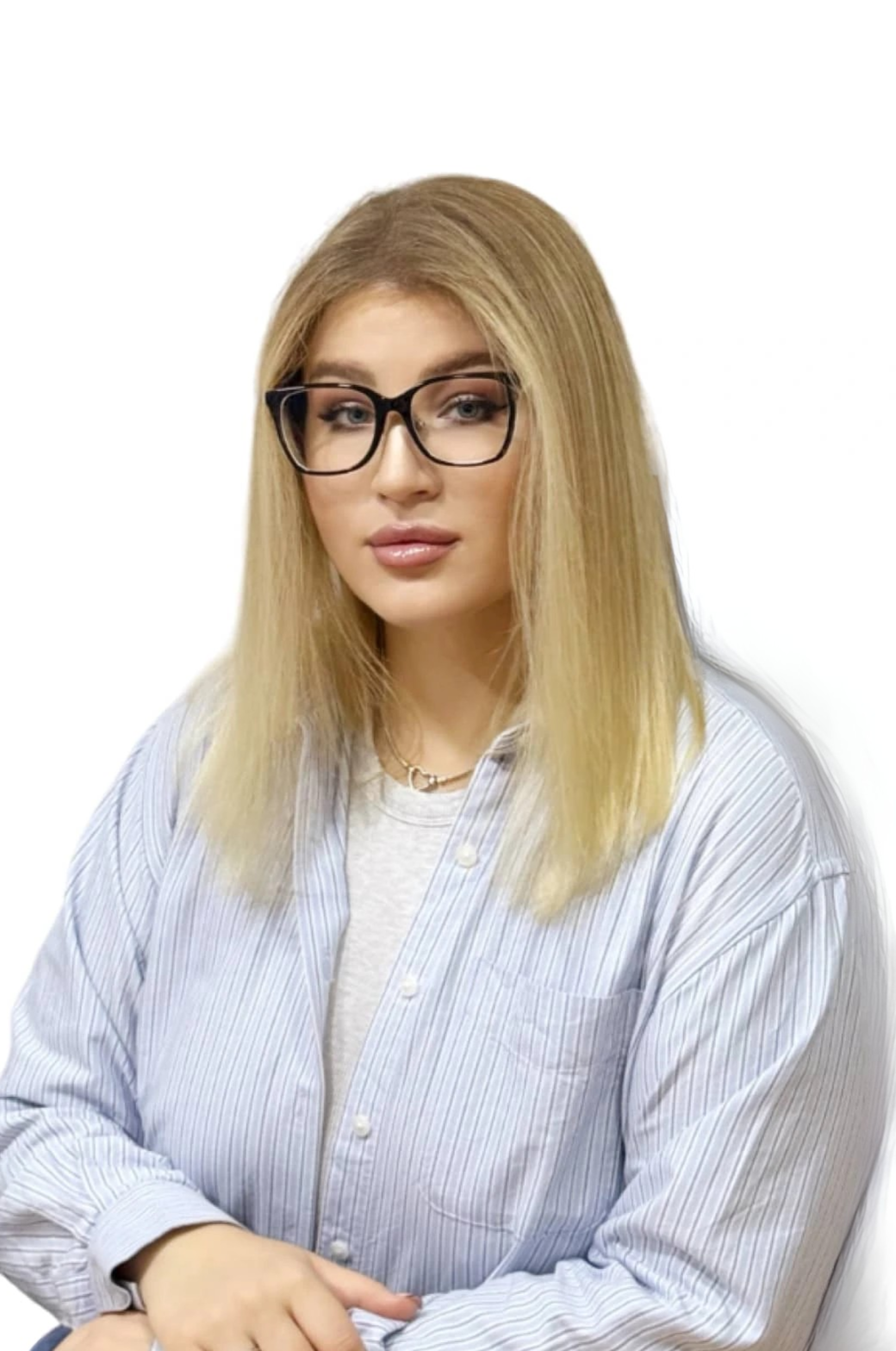 a woman with glasses sitting at a desk