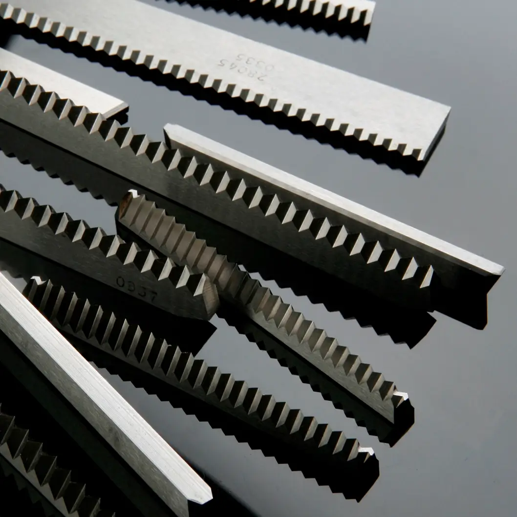 Multiple zig-zag flow wrap knives with precision-cut teeth, manufactured by Durham Duplex for efficient moving in production.
