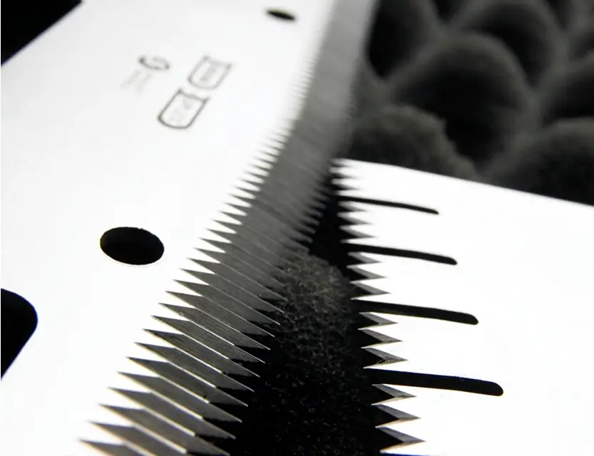 Close-up of industrial blades with fine sharp teeth, highlighting Durham Duplex's precision knife manufacturing.  