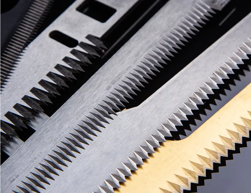 Close-up of multiple industrial packaging knives in gold and silver, highlighting Durham Duplex expertise in manufacturing high-performance knives.