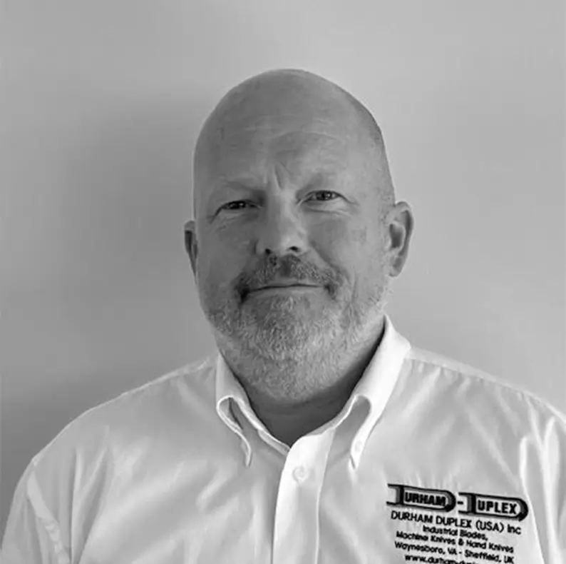 Black and white image of a male called Steve who is the group CEO, he is stood looking at the camera wearing Durham Duplex uniform. 