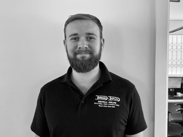 A male called Sam who is Durham Duplex's product specialist who is smiling towards the camera in his uniform.