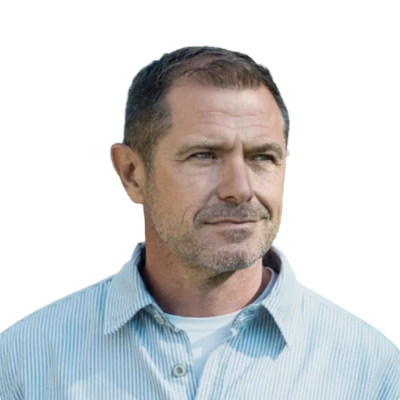 Middle-aged man with short hair and stubble wearing a blue striped button-up shirt looking right.
