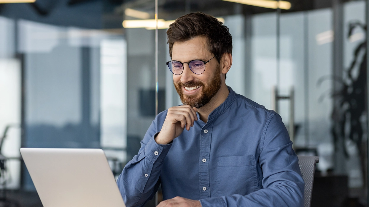 Man smiling at laptop