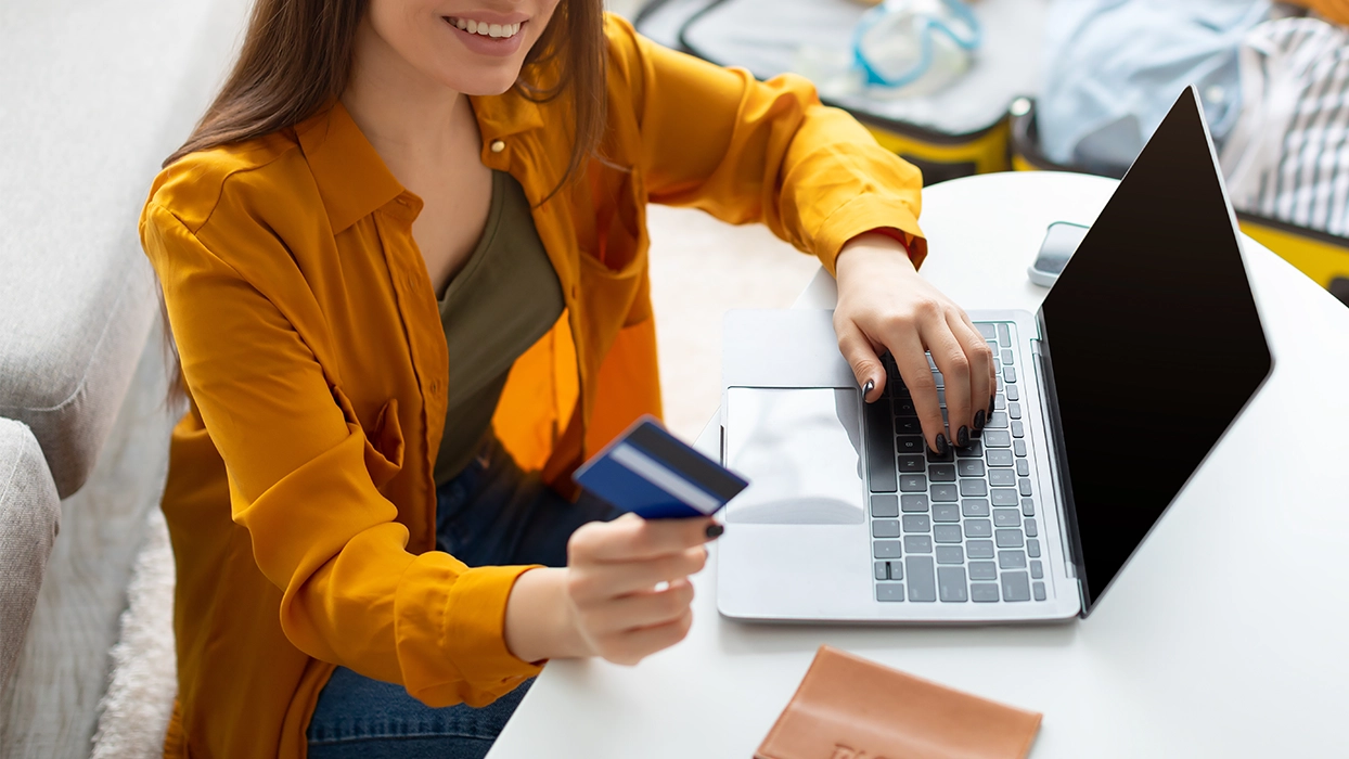 Woman paying for holiday with preferred currency