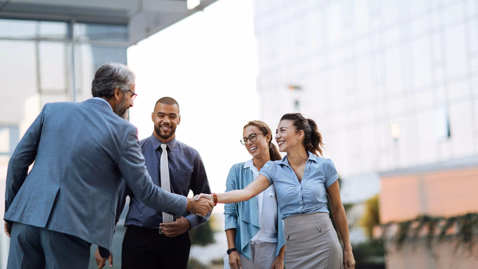 Business people shaking hands, representing Repayd partnering with Hands In