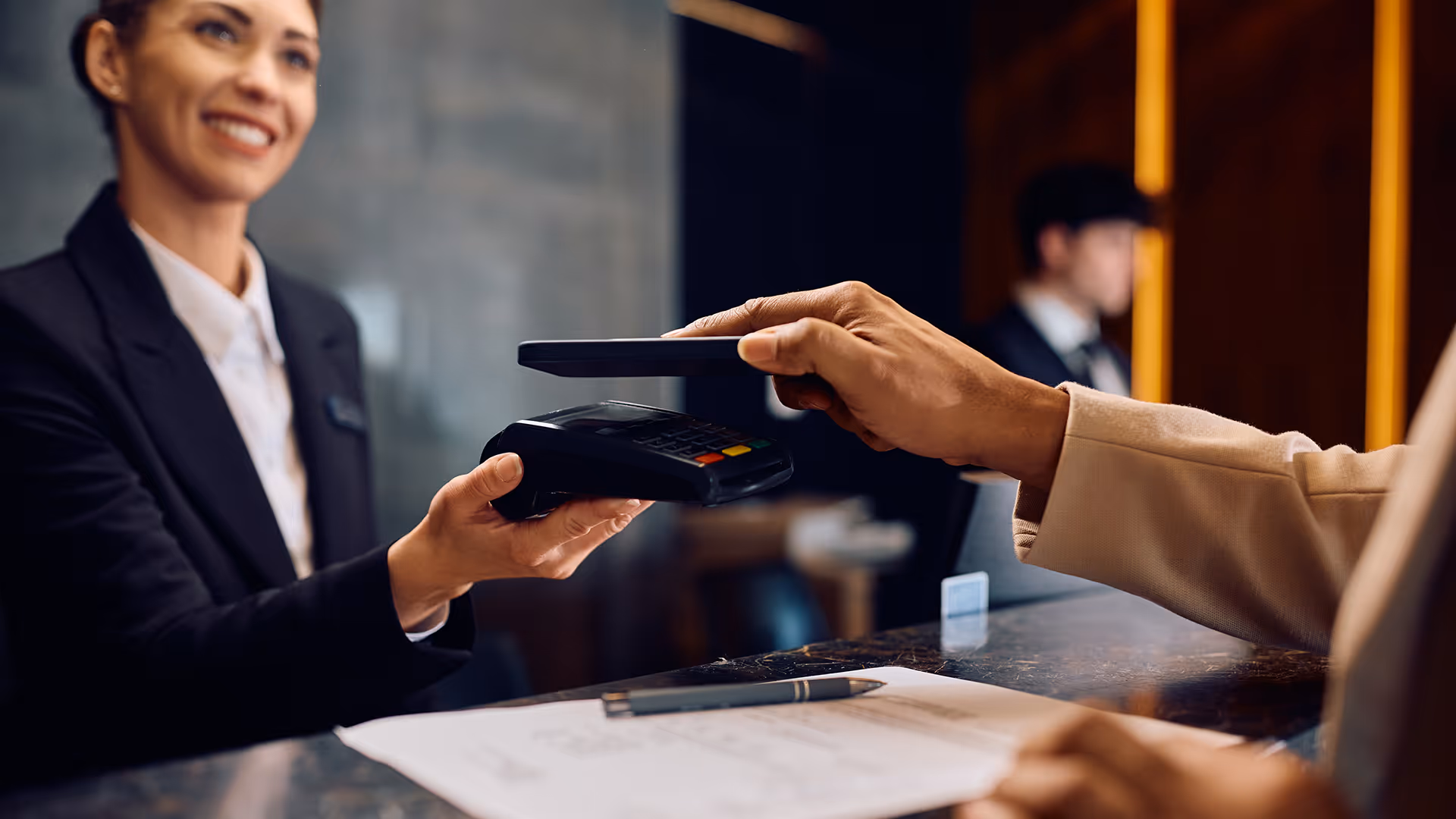 Man making a local card payment at a hotel