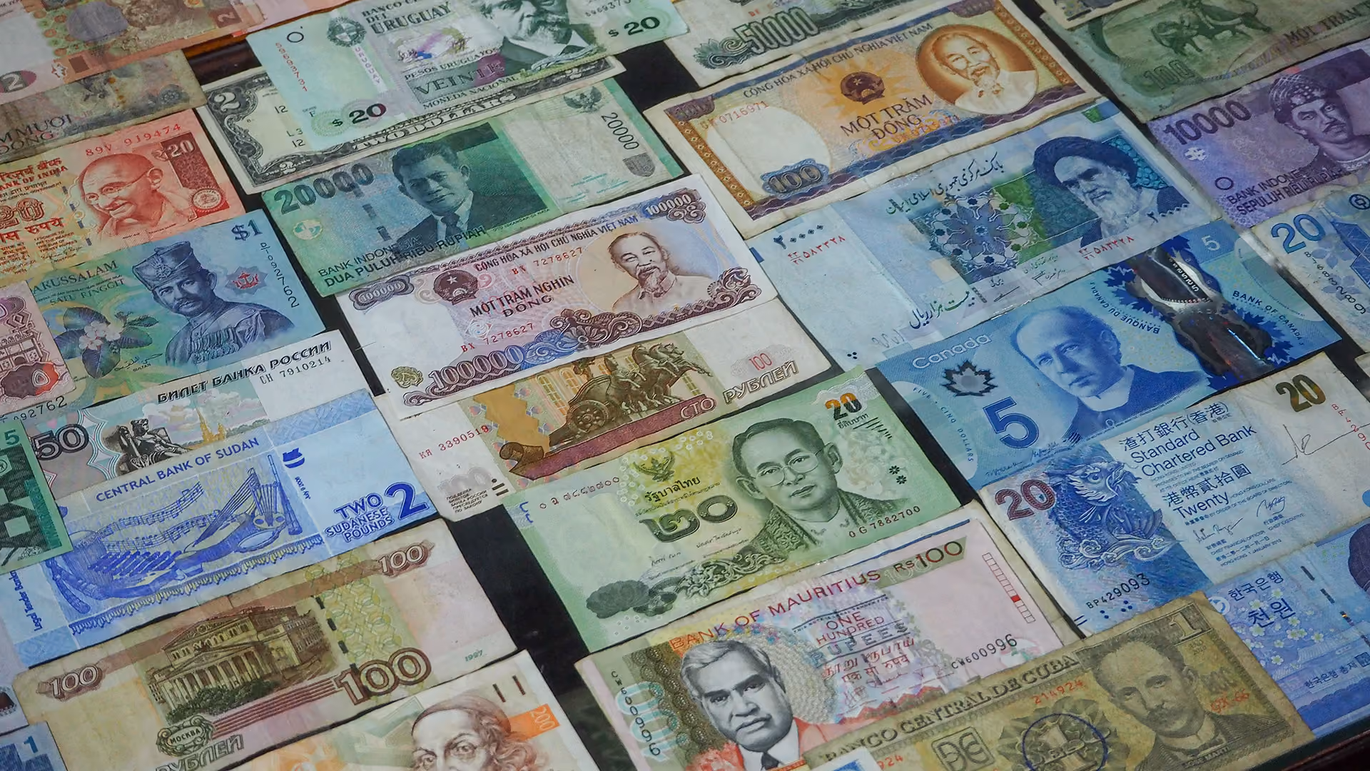 Bank notes from around the world, representing multi-currency payments