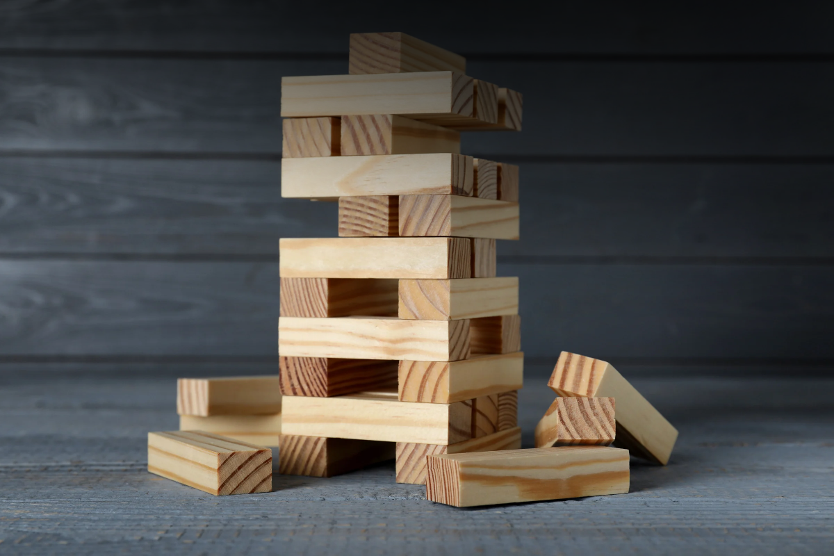 A woman holds a phone displaying a Google Gemini prompt and reply about llms.txt files. It's used to illustrate a blog by Fifty2M about the whether a website needs an llms.txt file to be cited in AI search results