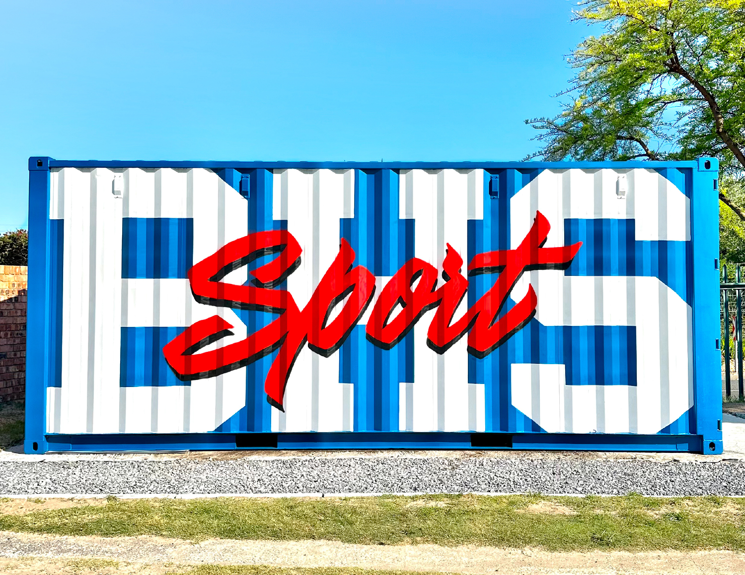 Blue and white shipping container with large white letters EHS and red cursive word Sport painted on it.