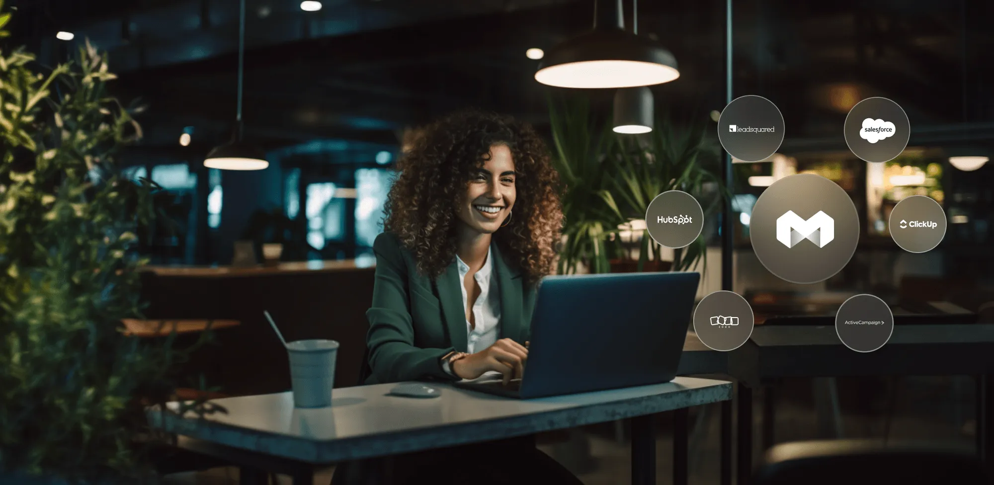 A woman sitting at a table with a laptop.