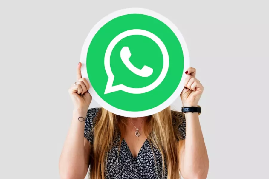Woman with WhatsApp's Logo in her hands