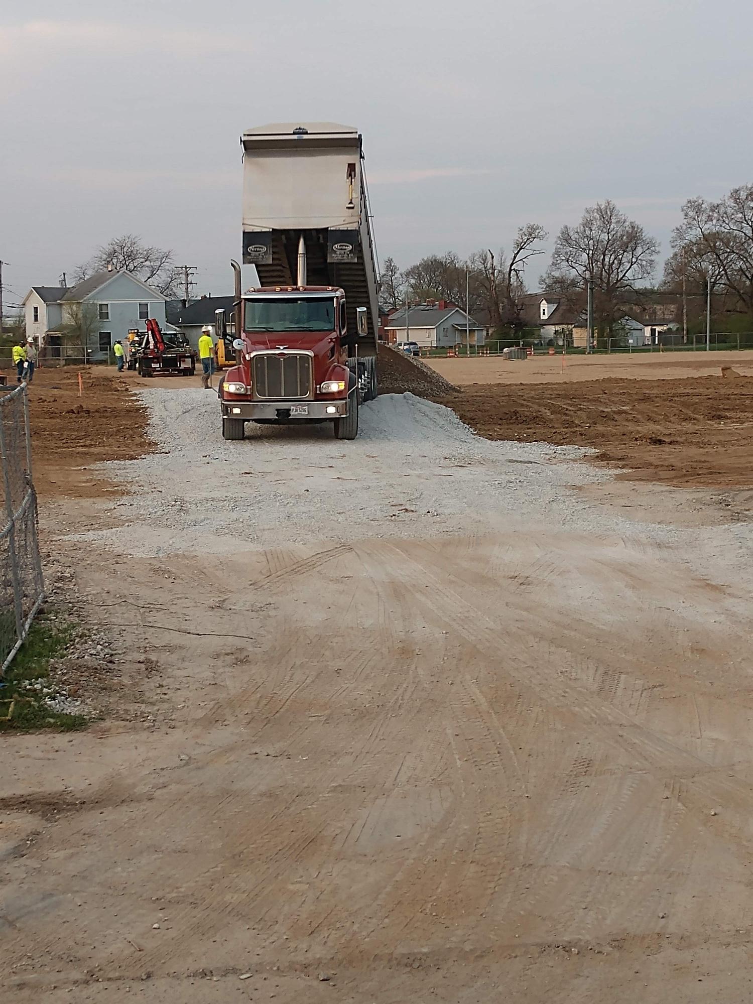 A dump truck unloading dirt