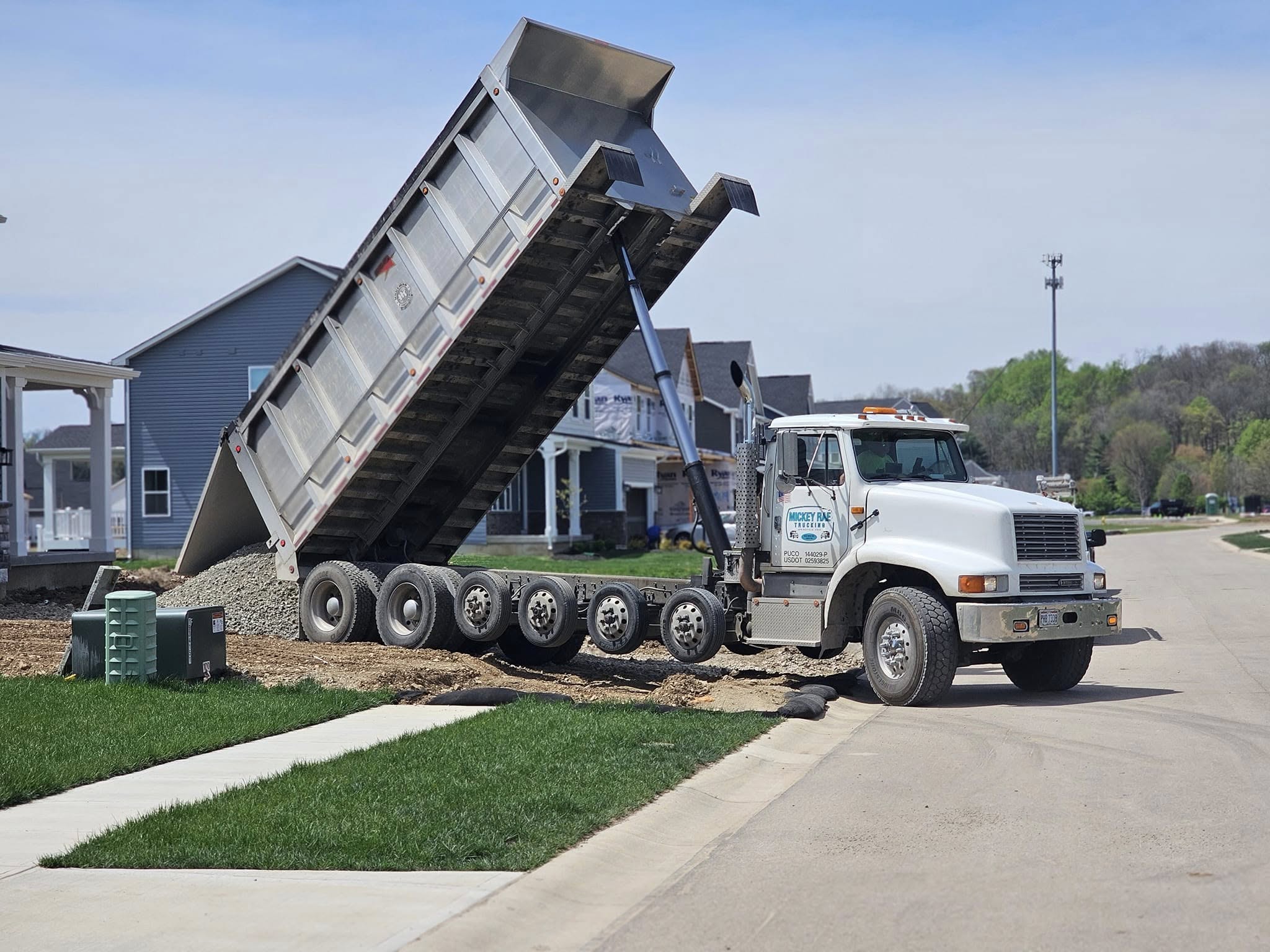 A dump truck unloading gravel or aggregate material