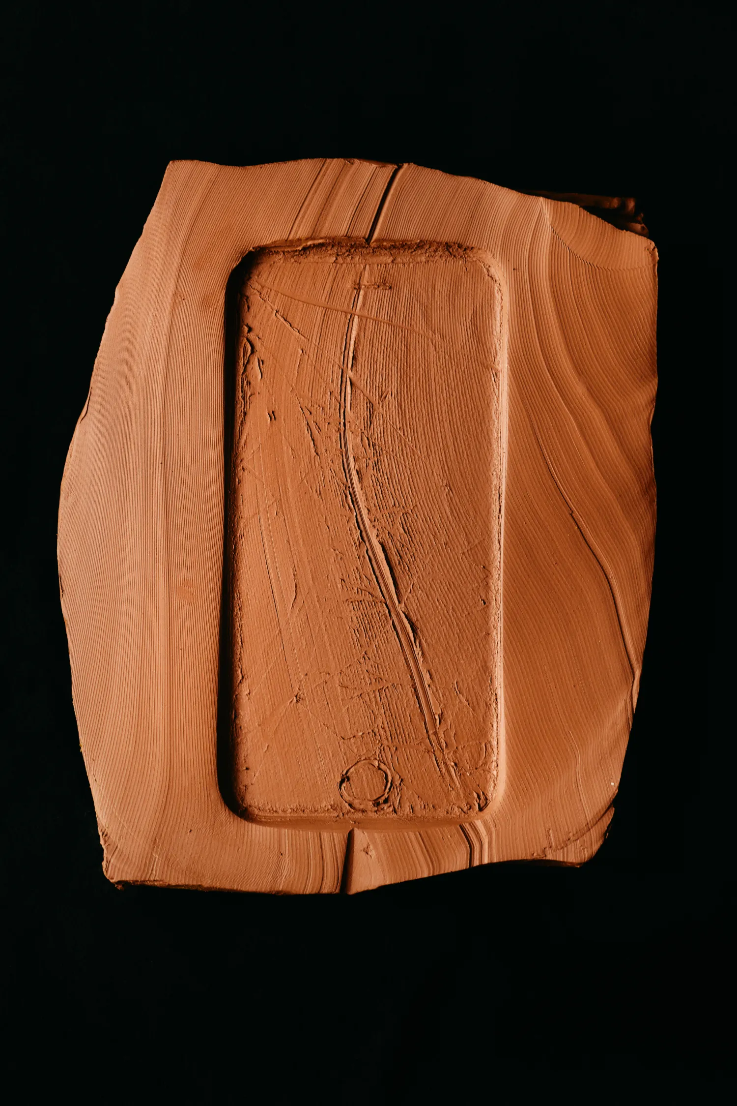 A wooden box with a cell phone inside.