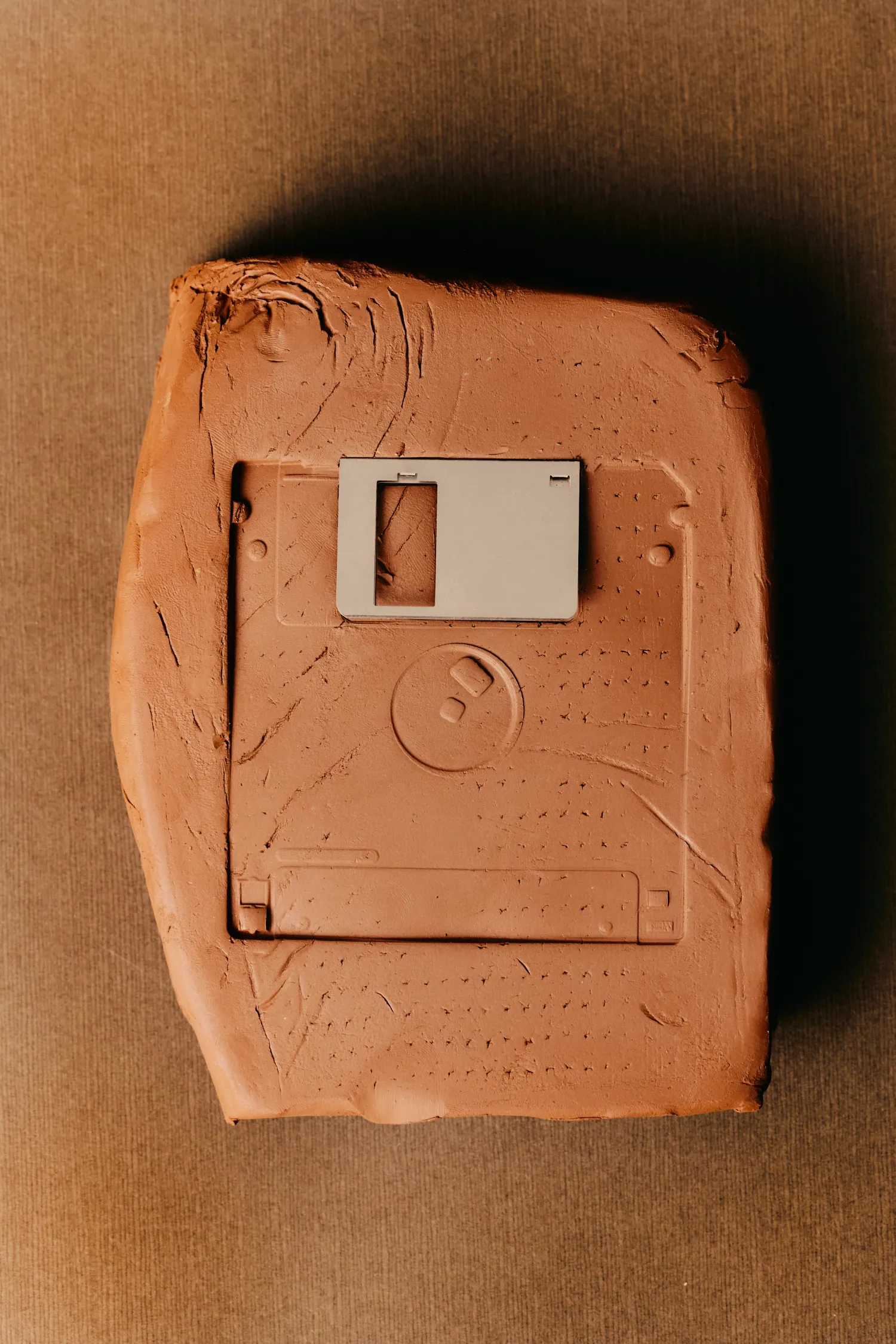 A clay model of a floppy disk.