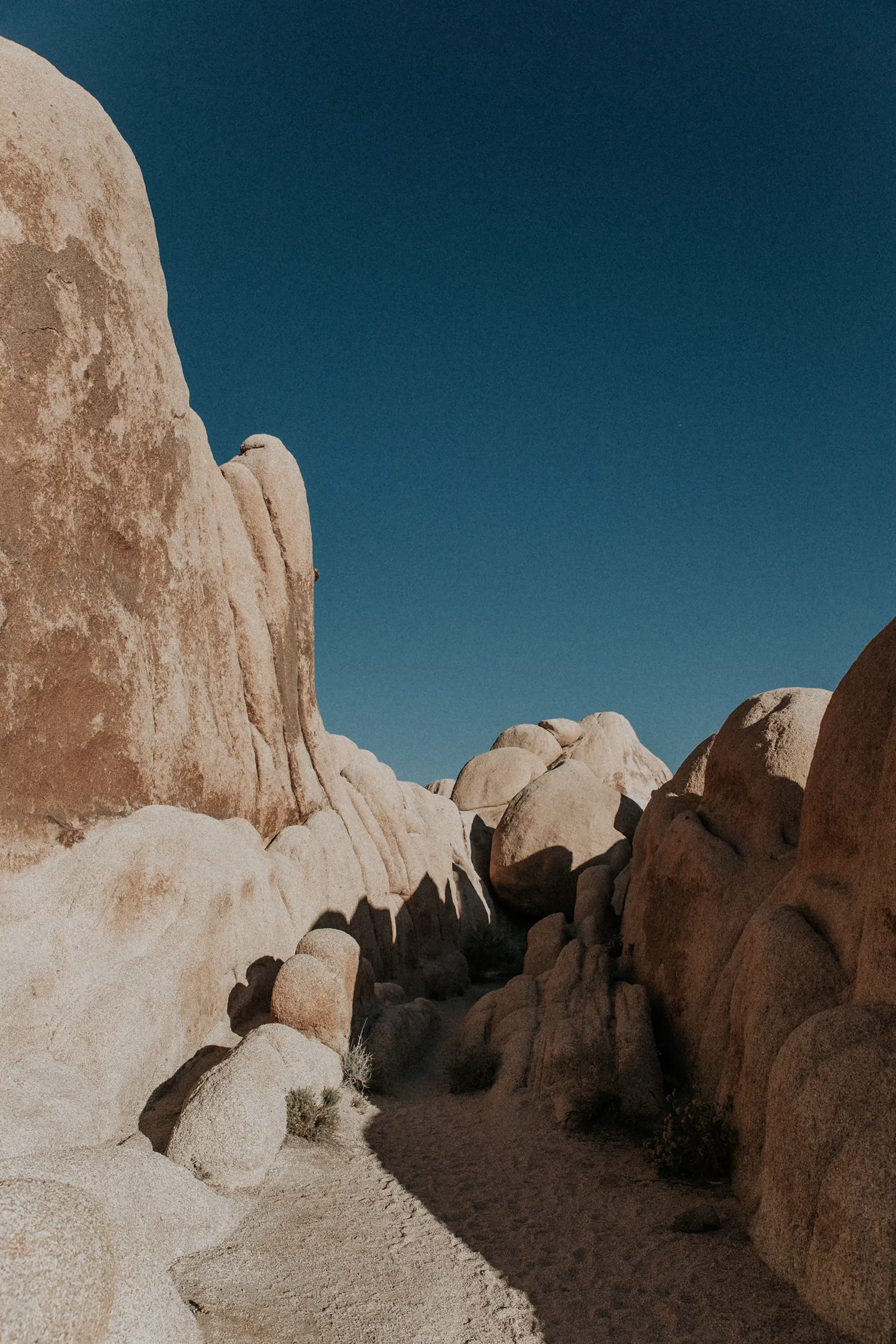A rocky mountain with a blue sky above.
