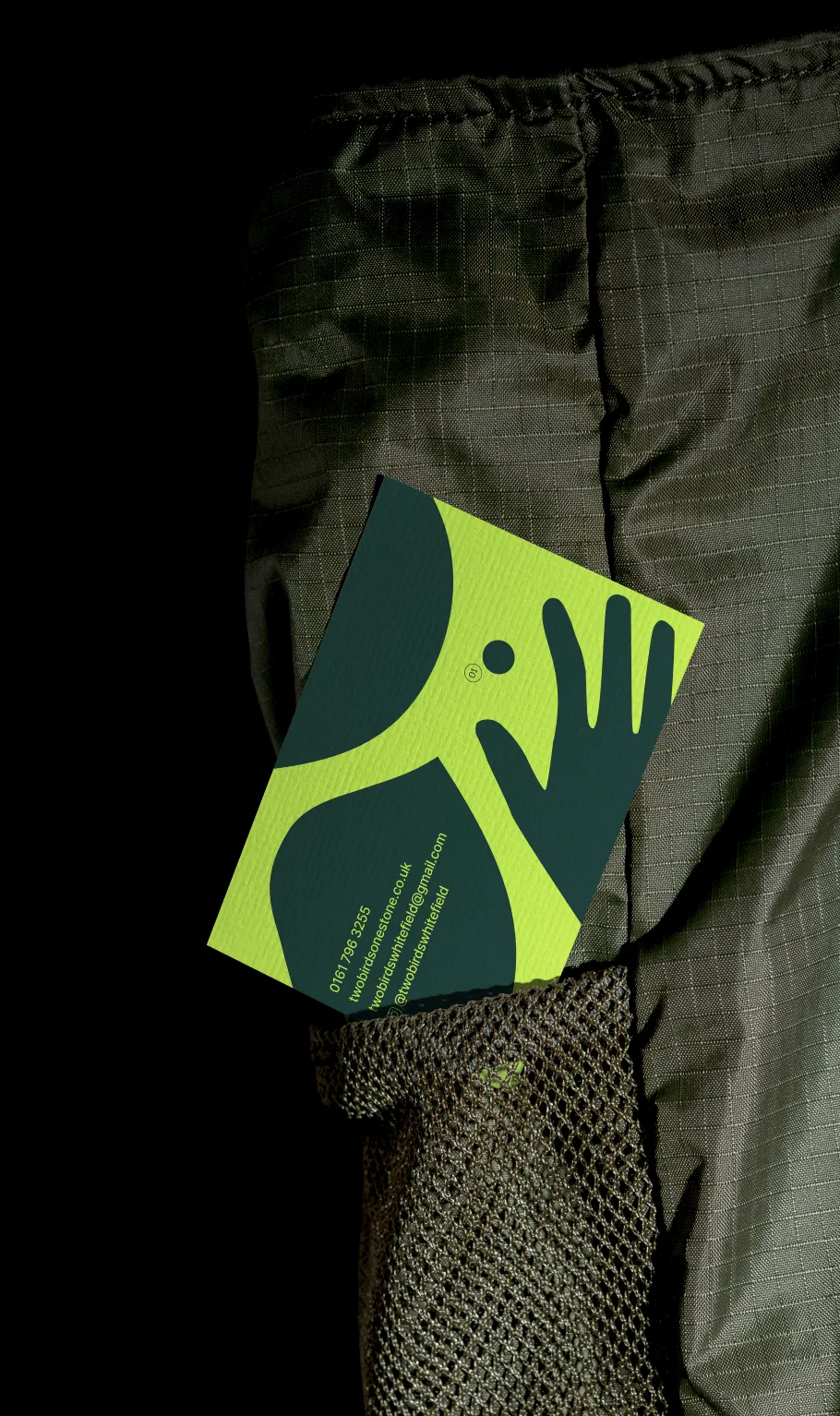 Business card for two birds and one stone showing green illustrations and contact information