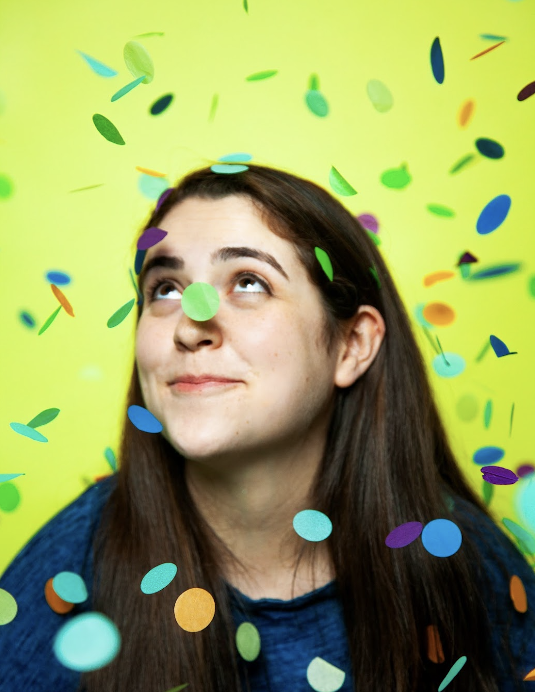 Sammy looking up, with confetti falling around her.