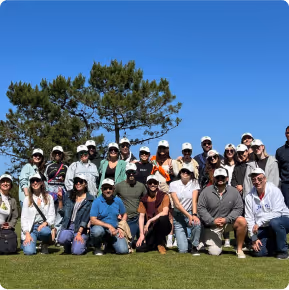 Team building event with everyone taking a picture outside on the garden