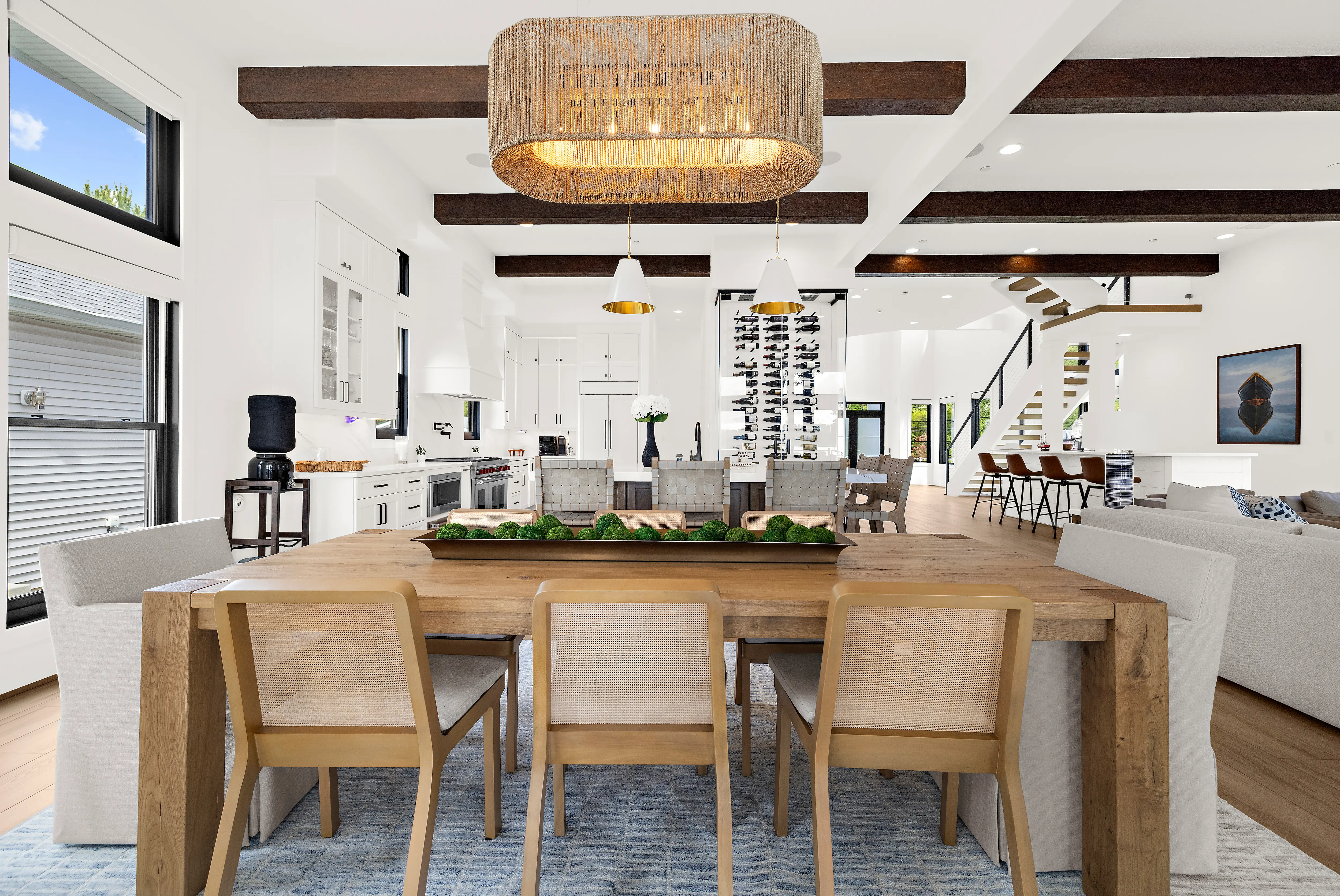 Cadle Creek - Rhode River completed home showing dining table and view of kitchen, living room, and stairs in the background