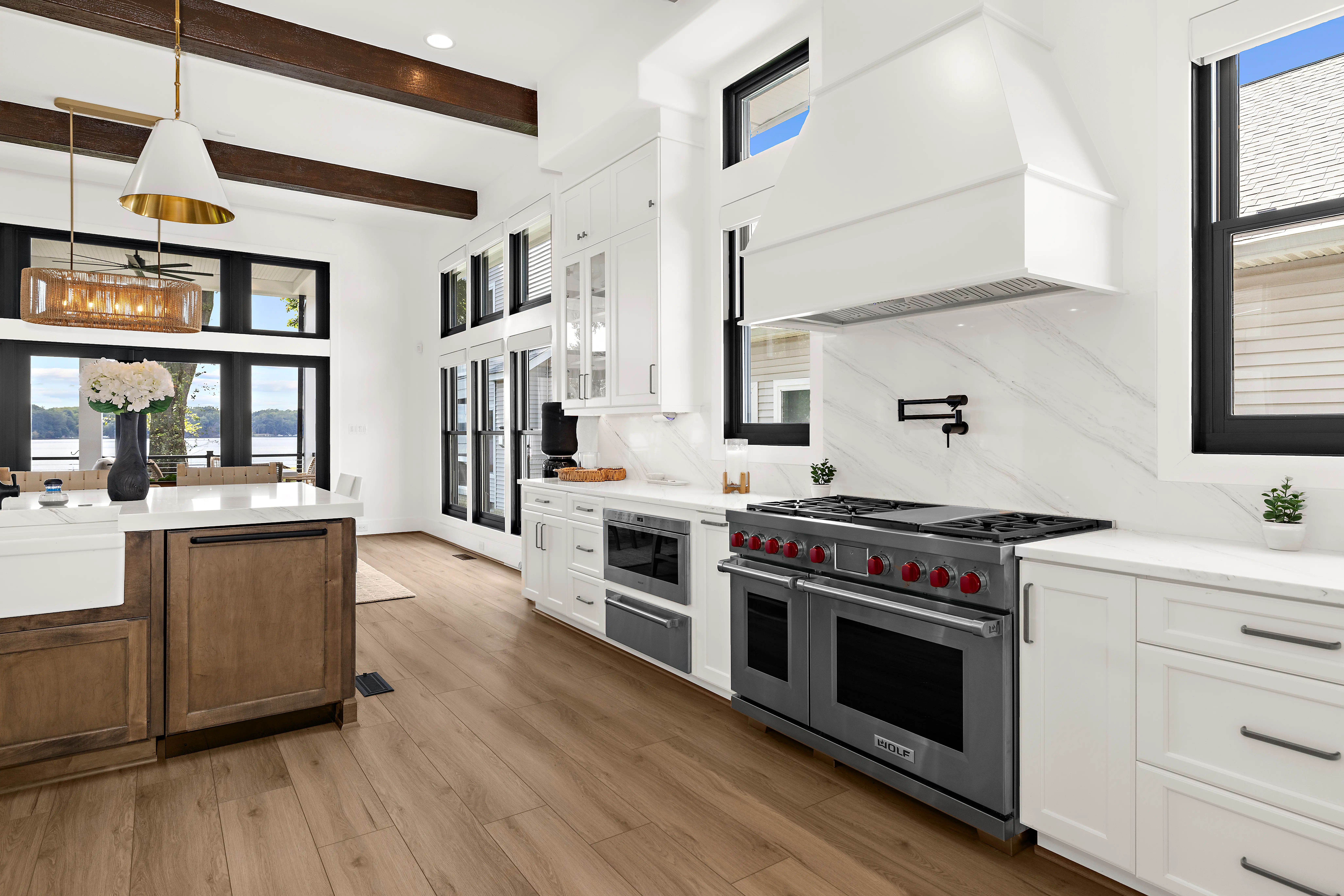 Cadle Creek - Rhode River completed home showing kitchen, island, and part of dining area.