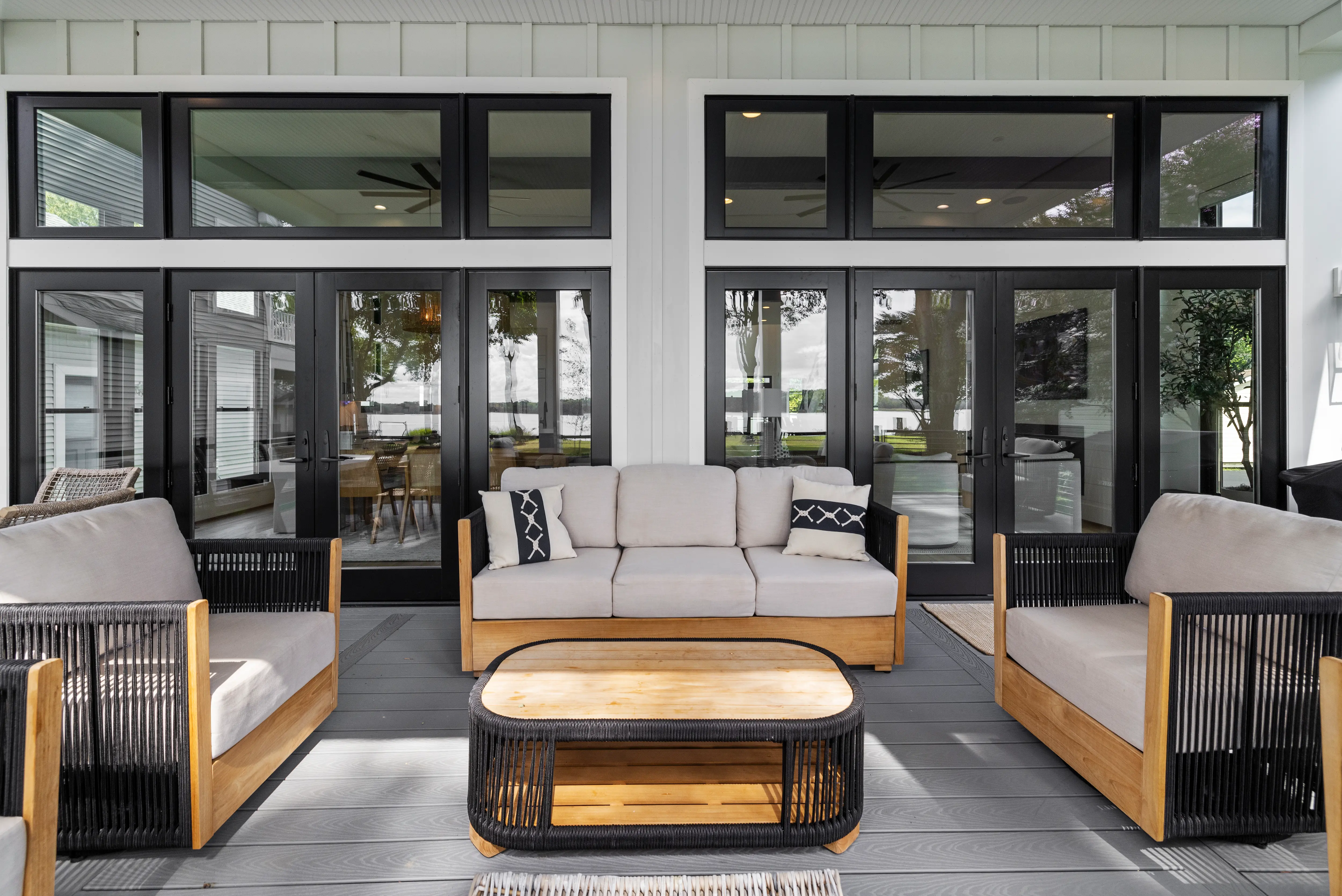 Cadle Creek - Rhode River completed home showing furnished porch with wide glass doors. 