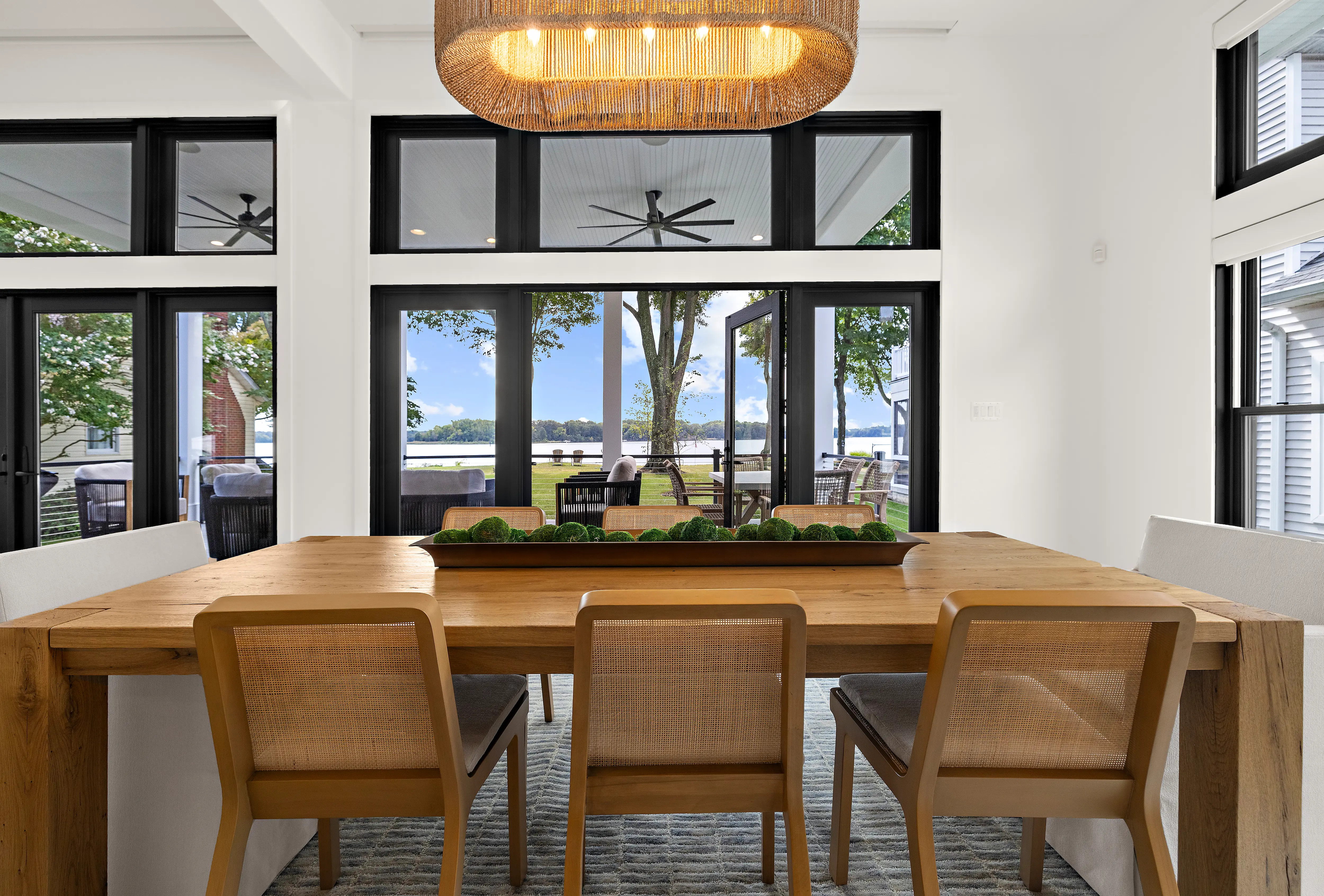 Dining room area with glass doors opening to rear water view