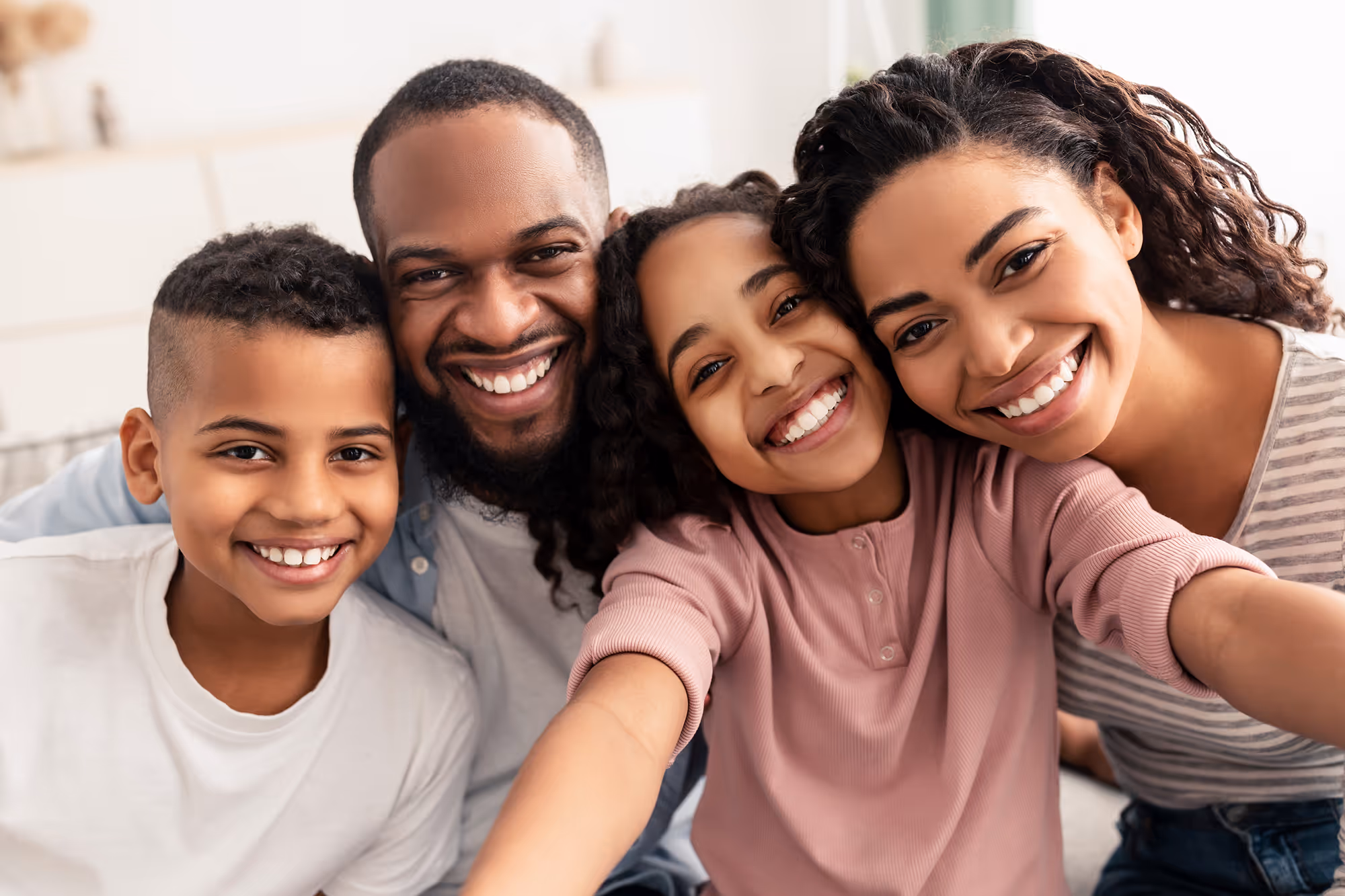 A group of people that are smiling for the camera.