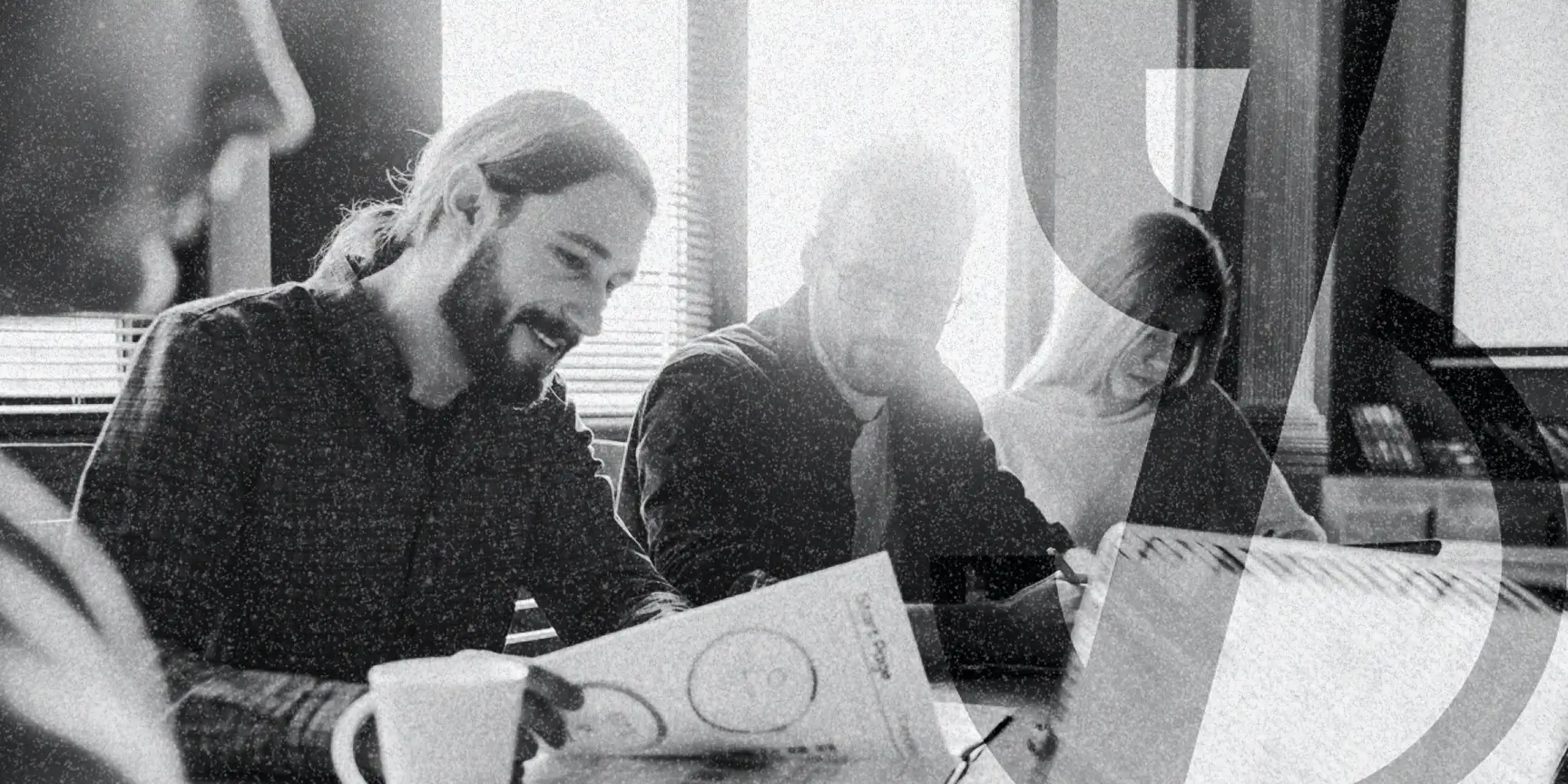 Group of people around a table reviewing their nonprofit marketing guide for 2025