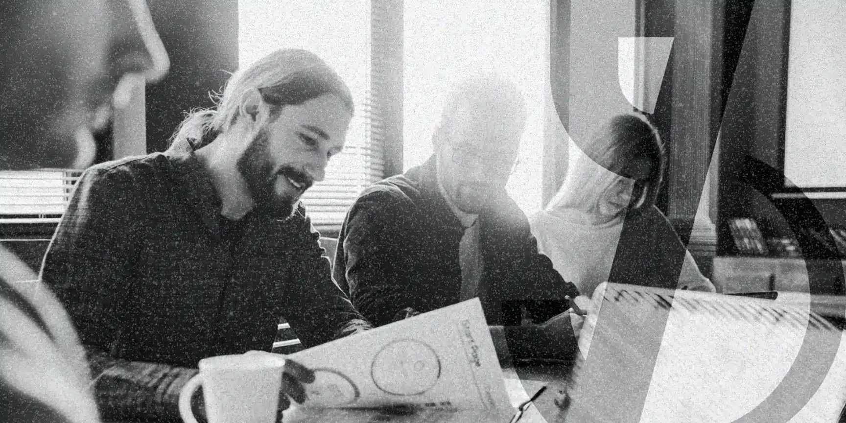 Group of people around a table reviewing their nonprofit marketing guide for 2025